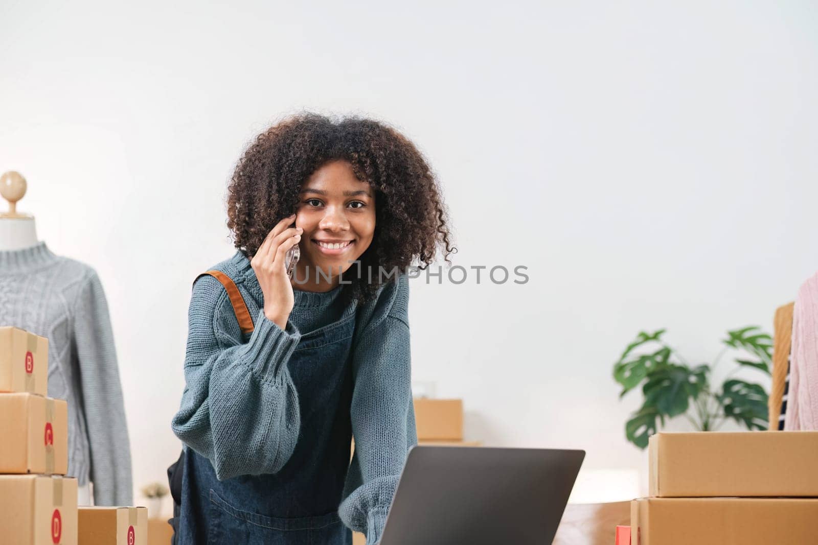 Startup Small business owner entrepreneur. Young asian business woman using mobile phone call receiving purchase order and check product on stock. E-commerce business and shopping online concept...