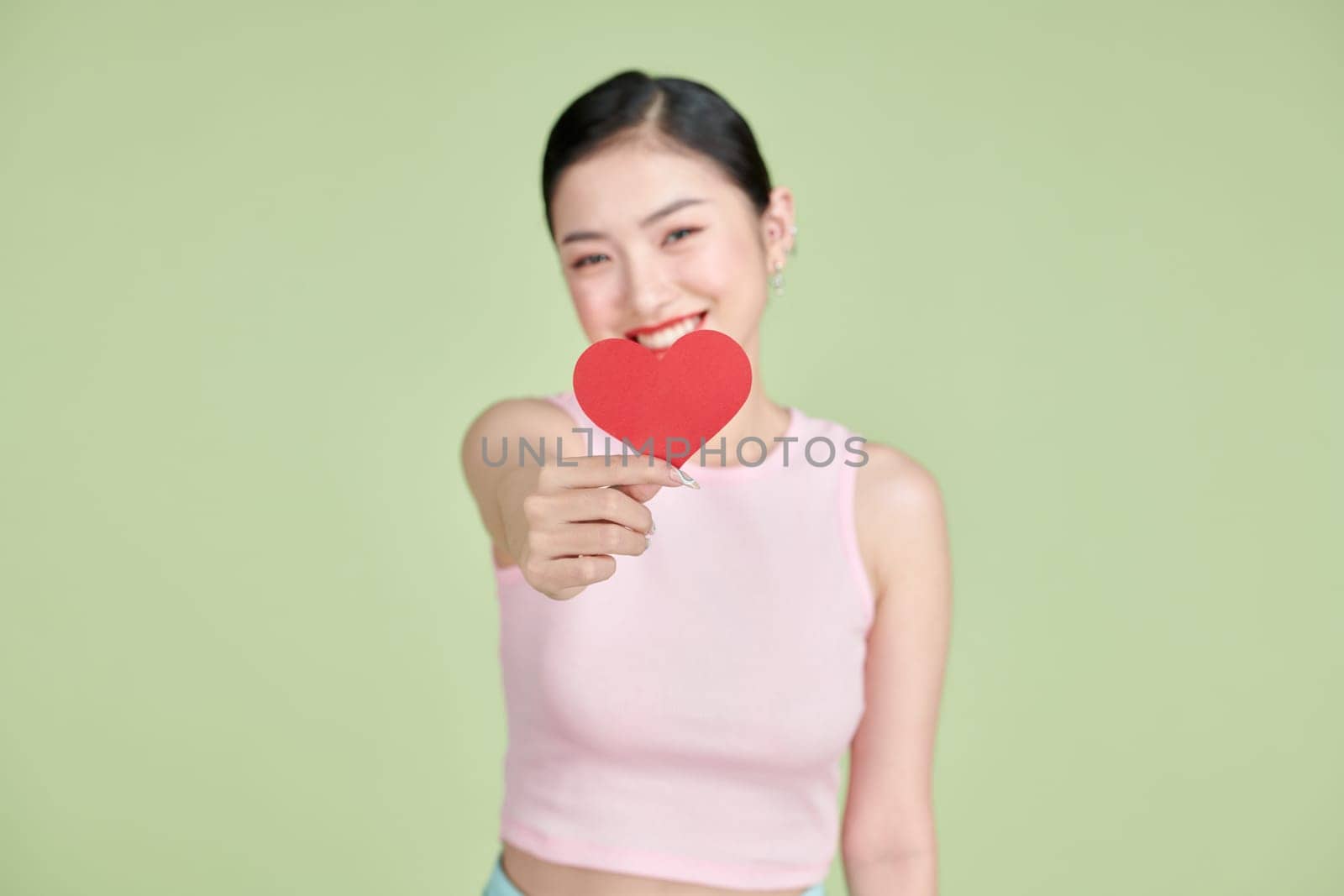 exhilarated woman holding a valentine greeting card in hands  by makidotvn