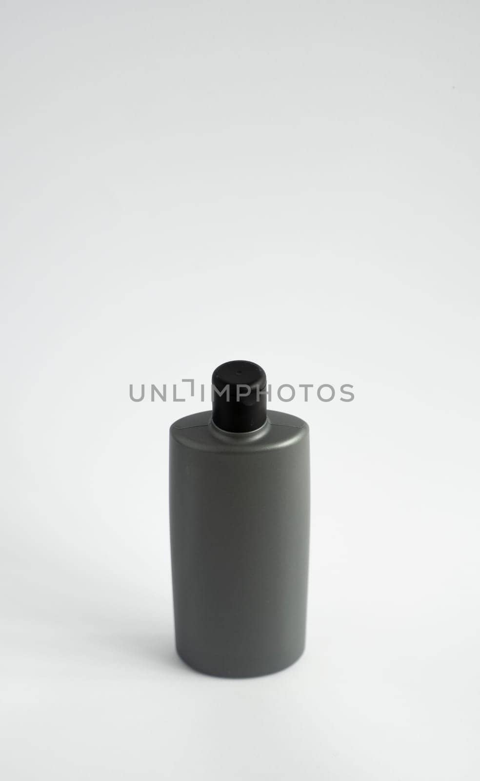 Black shampoo packaging mockup. Vertical empty plastic cosmetic package for man, isolated on white background. Container of conditioner, hair rinse