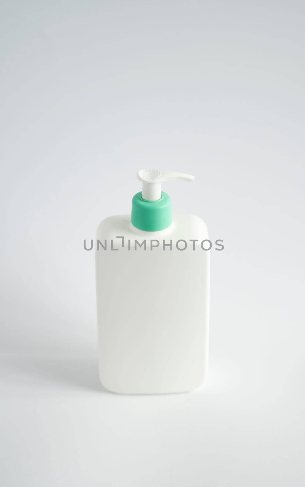 Large white plastic bottle with pump dispenser as a liquid container for gel, lotion, cream, shampoo, bath foam on white background