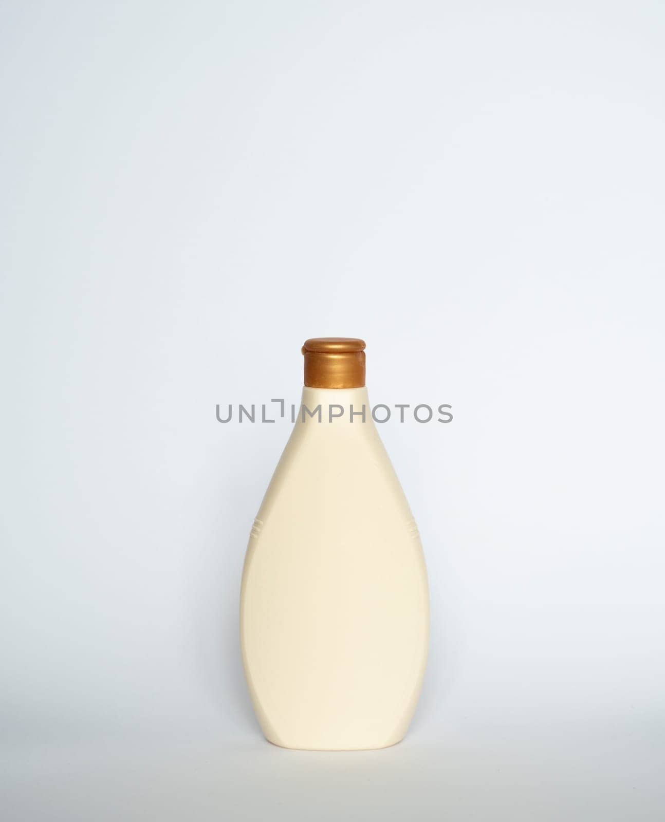 Beige blank plastic bottles isolated on white background