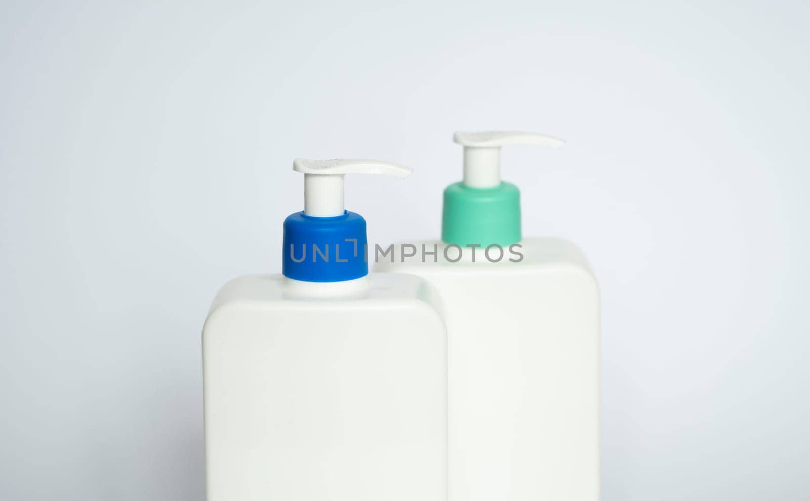 Two white plastic bottles with black dispenser, isolated on white background by vovsht