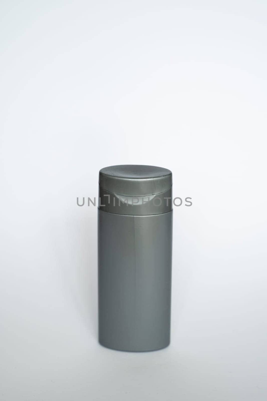Black shampoo packaging mockup. Vertical empty plastic cosmetic package for man, isolated on white background. Container of conditioner, hair rinse