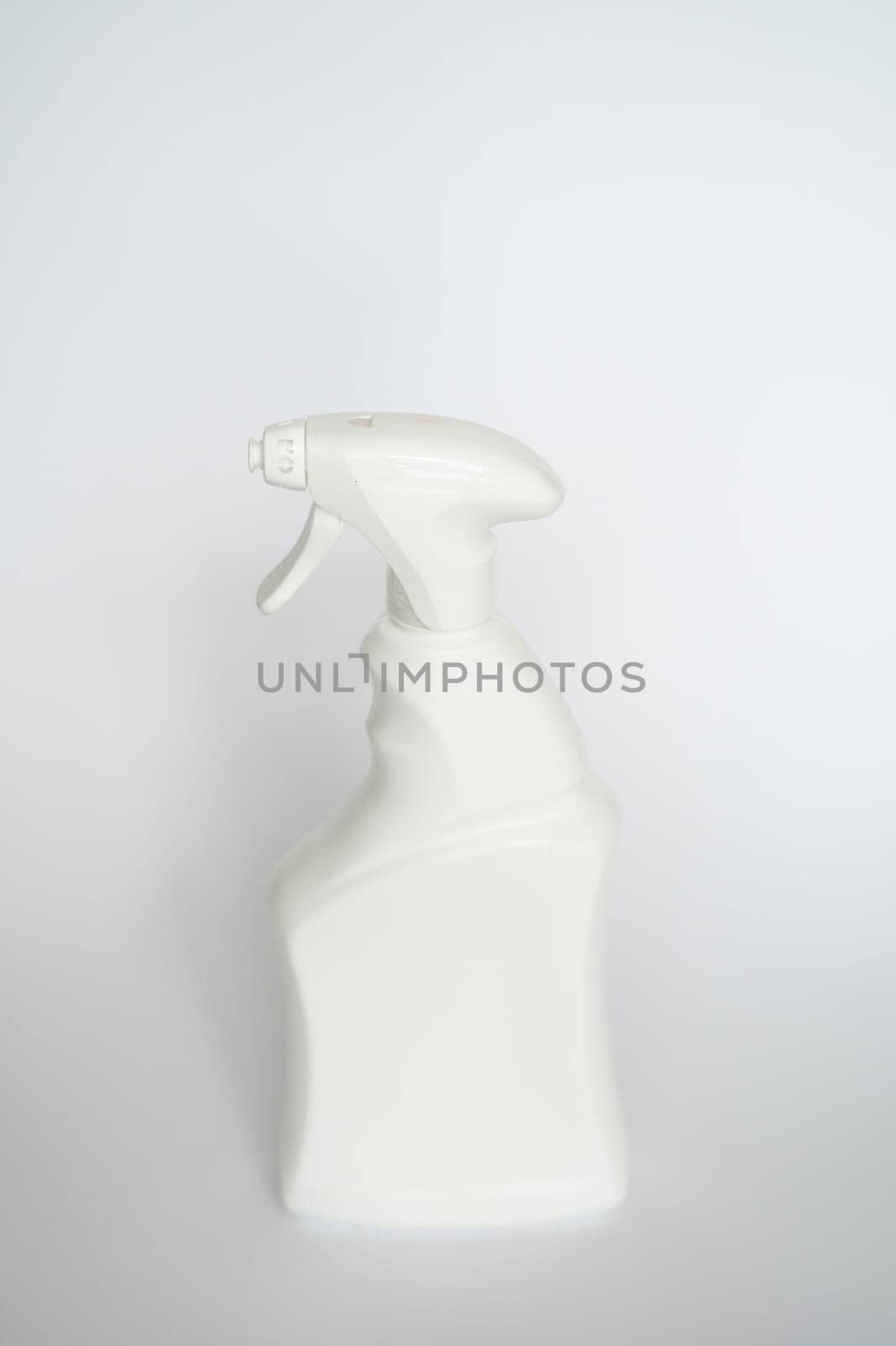 White plastic spray bottle for liquid cleaning products isolated on white background. Packaging mockup bottle with sprayer.
