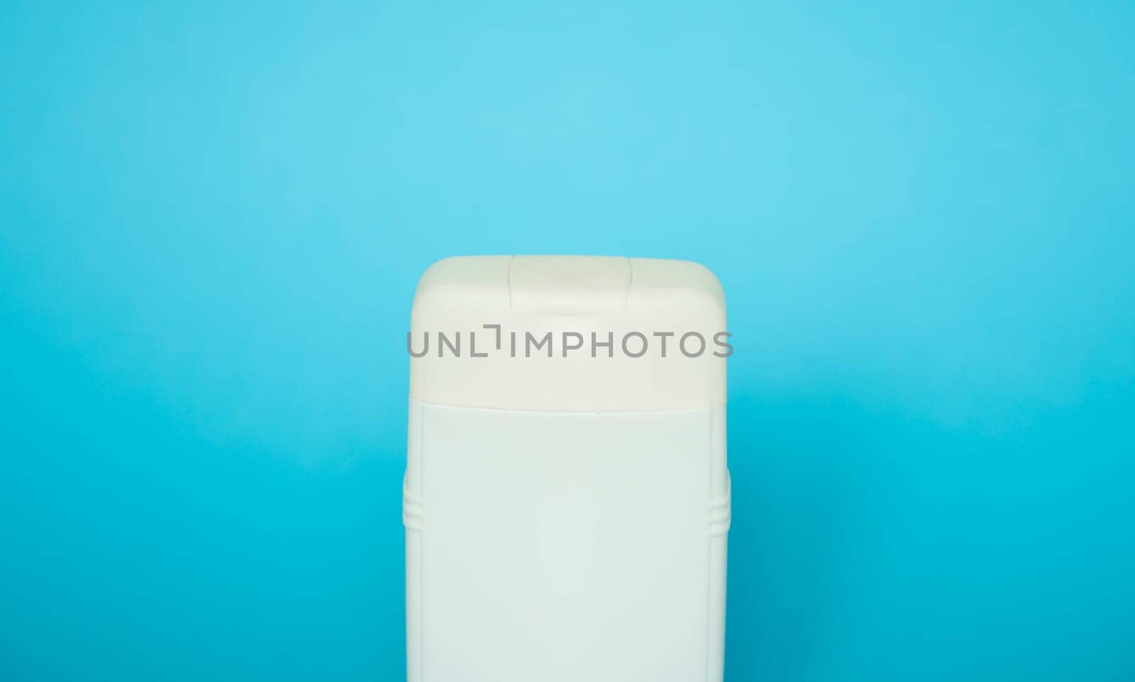 White square bottle for liquid soap, shampoo, gel on blue background