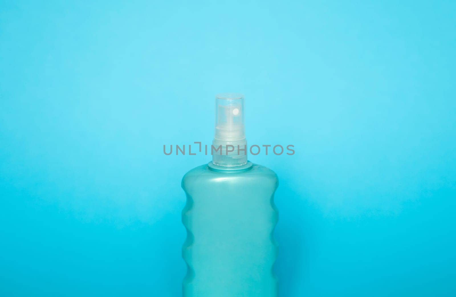 Blue blank unbranded cosmetic plastic bottle for shampoo, gel, lotion, cream, bath foam blue background