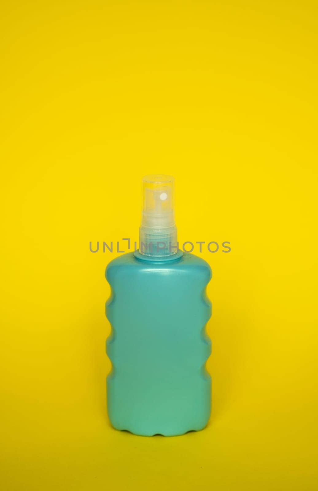 Blue blank unbranded cosmetic plastic bottle for shampoo, gel, lotion, cream, bath foam yellow background. by vovsht