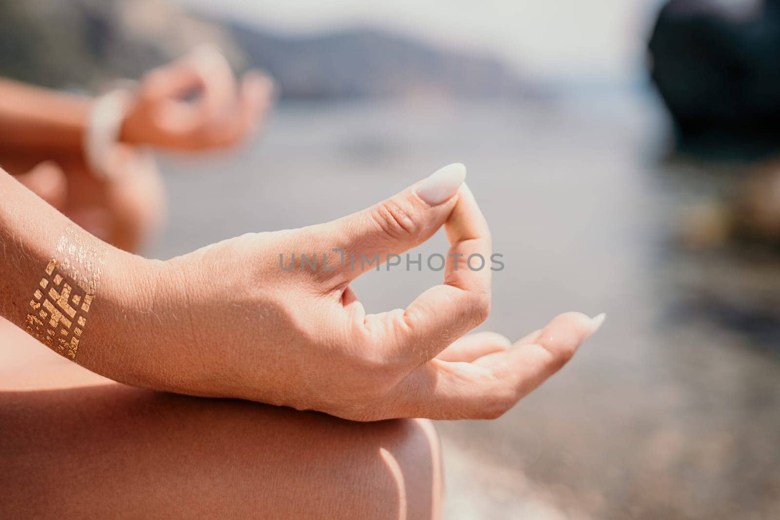 Woman sea yoga. Back view of free calm happy satisfied woman with long hair standing on top rock with yoga position against of sky by the sea. Healthy lifestyle outdoors in nature, fitness concept.