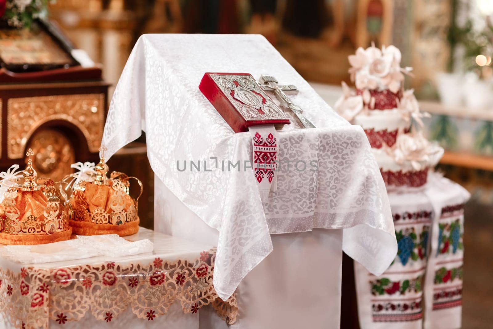 Two crowns the weddings intended for ceremony in orthodox church. Orthodox wedding accessories Holy Bible and silver cross.