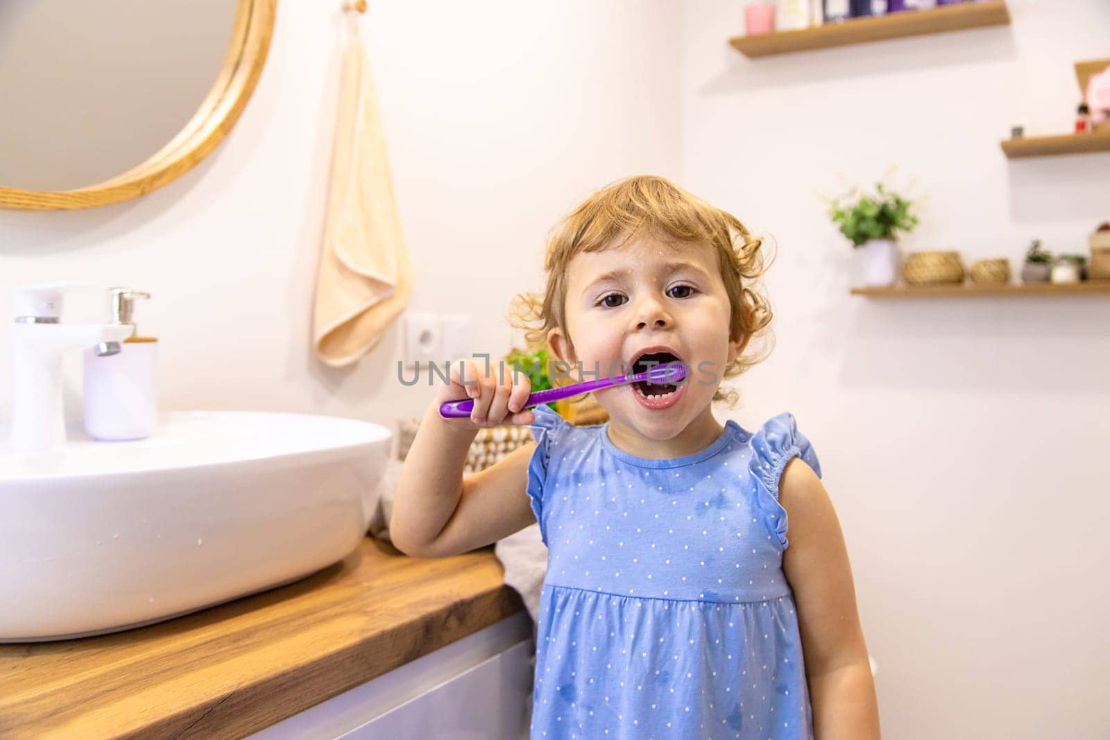 The child brushes his teeth in the bathroom. Selective focus. Nature.
