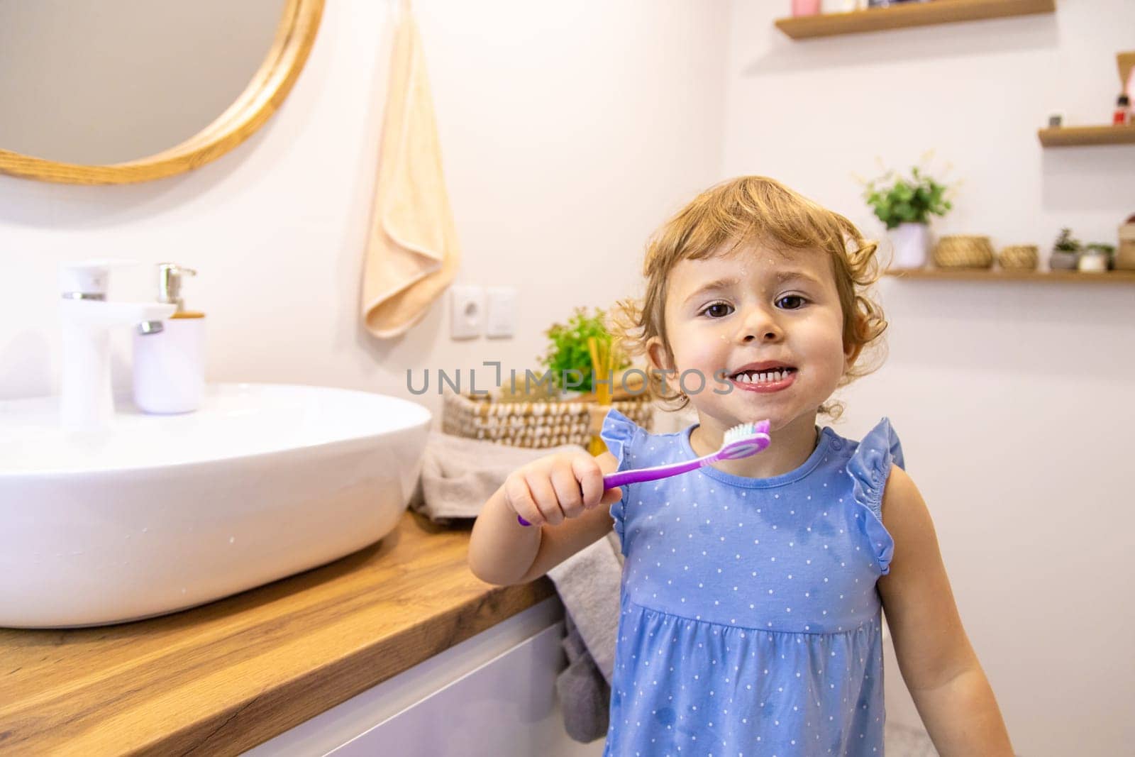 The child brushes his teeth in the bathroom. Selective focus. Nature.