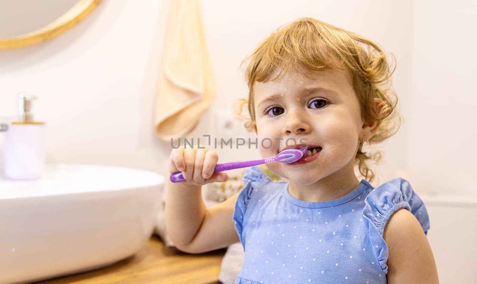The child brushes his teeth in the bathroom. Selective focus. Nature.