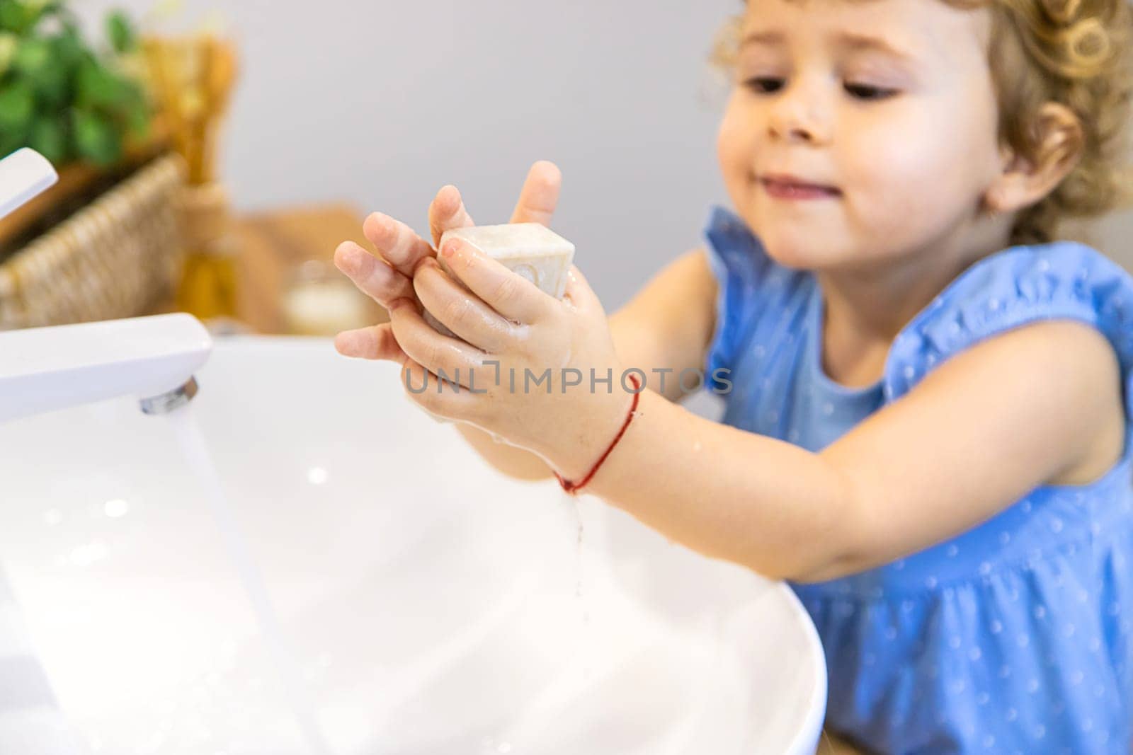The child washes his hands with soap. Selective focus. Kid.