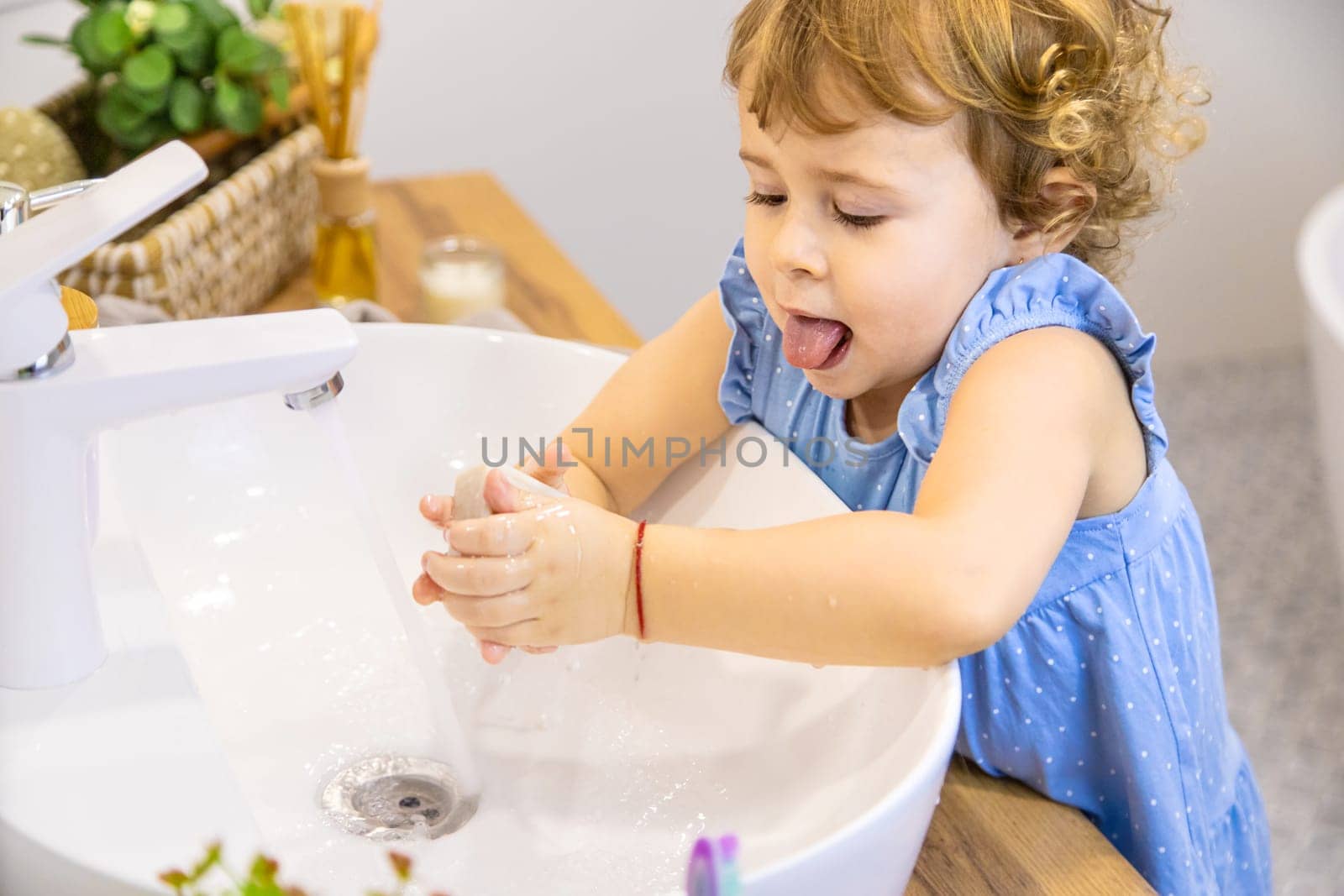 The child washes his hands with soap. Selective focus. Kid.