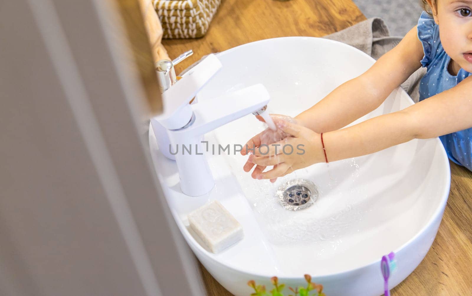 The child washes his hands with soap. Selective focus. Kid.