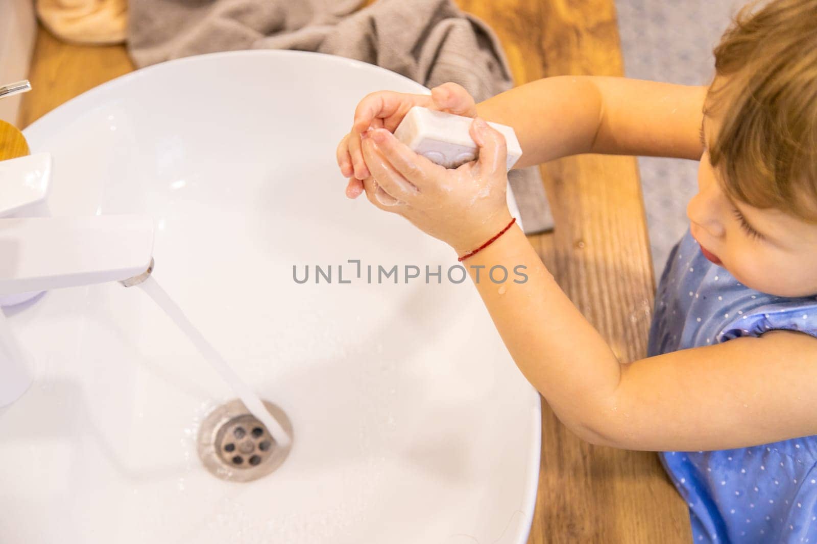 The child washes his hands with soap. Selective focus. Kid.