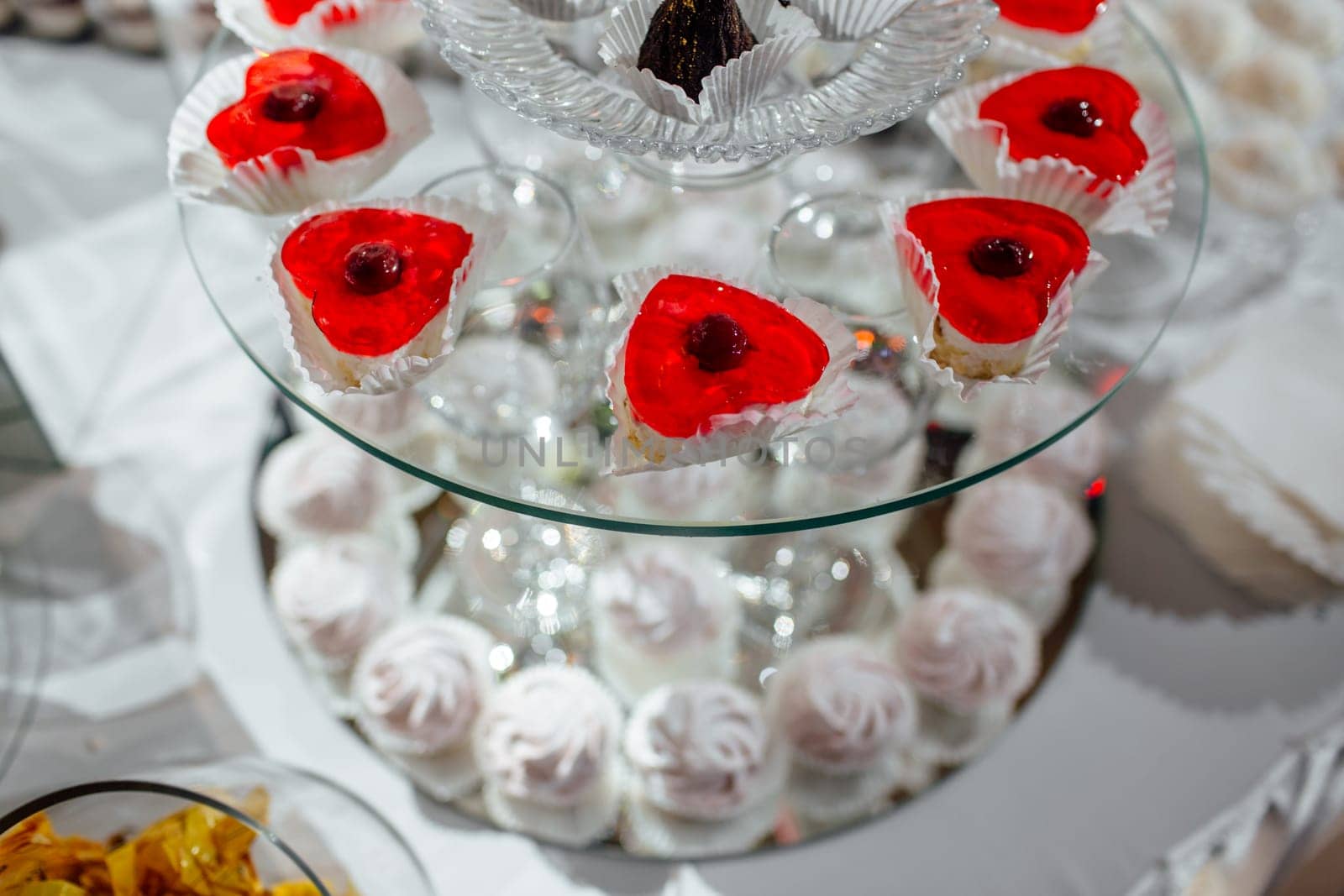 delicious candy bar at luxury wedding reception. exclusive expensive catering. table with modern desserts, cupcakes, sweets with fruits. baby or bridal shower. holiday celebration. selective focus
