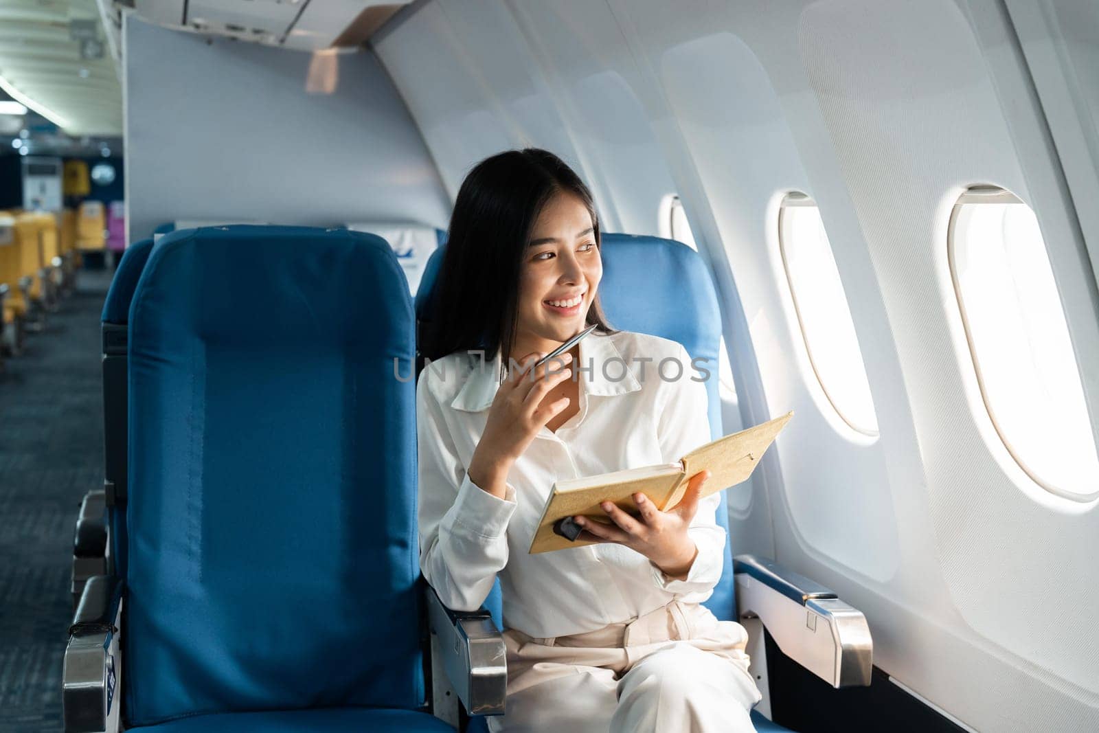 Asian female thinking about work in airplane concept Business traveling and technology concept by nateemee