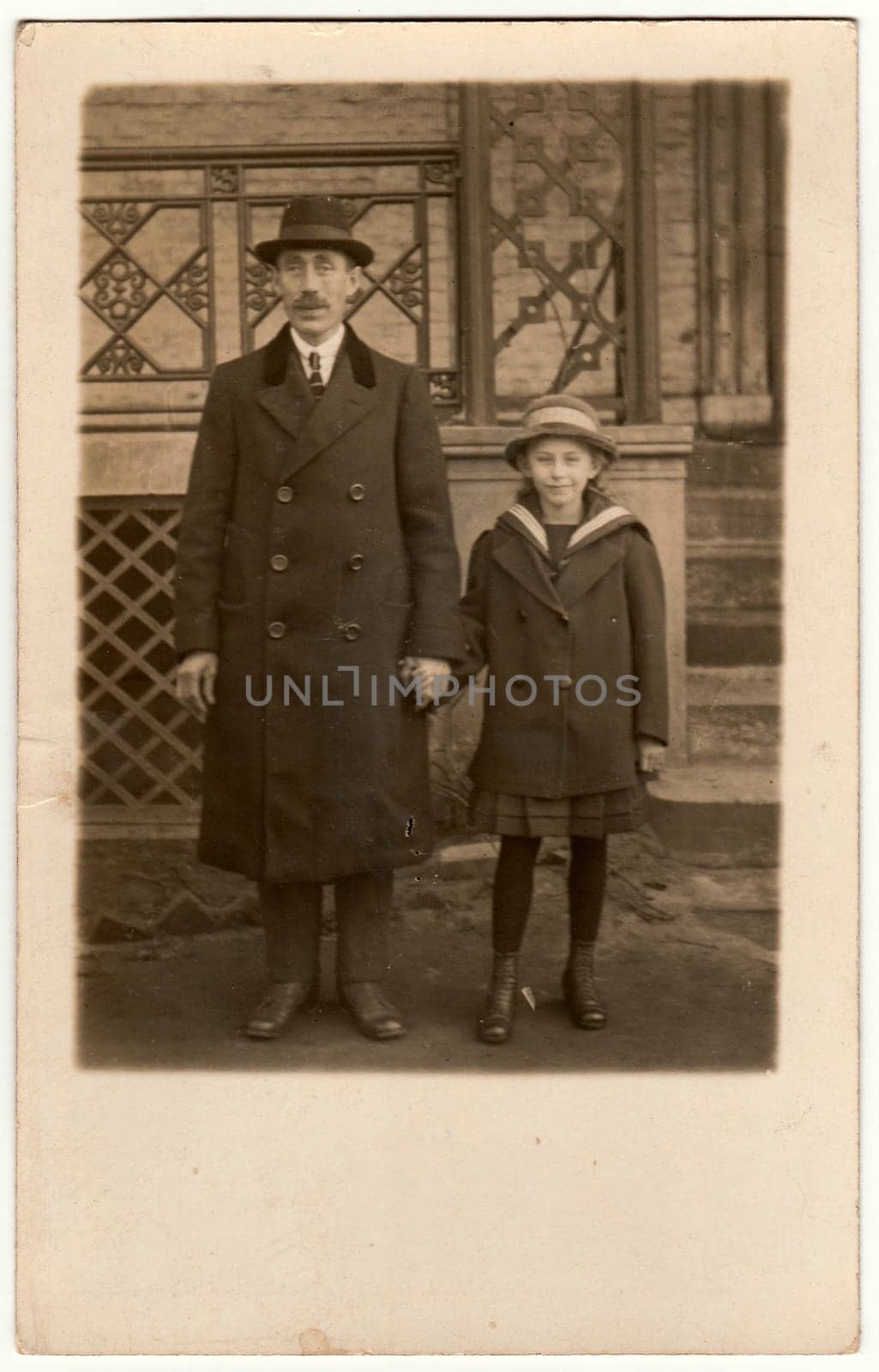 Vintage photo shows father with daughter pose outdoors. Retro black and white photography. by roman_nerud