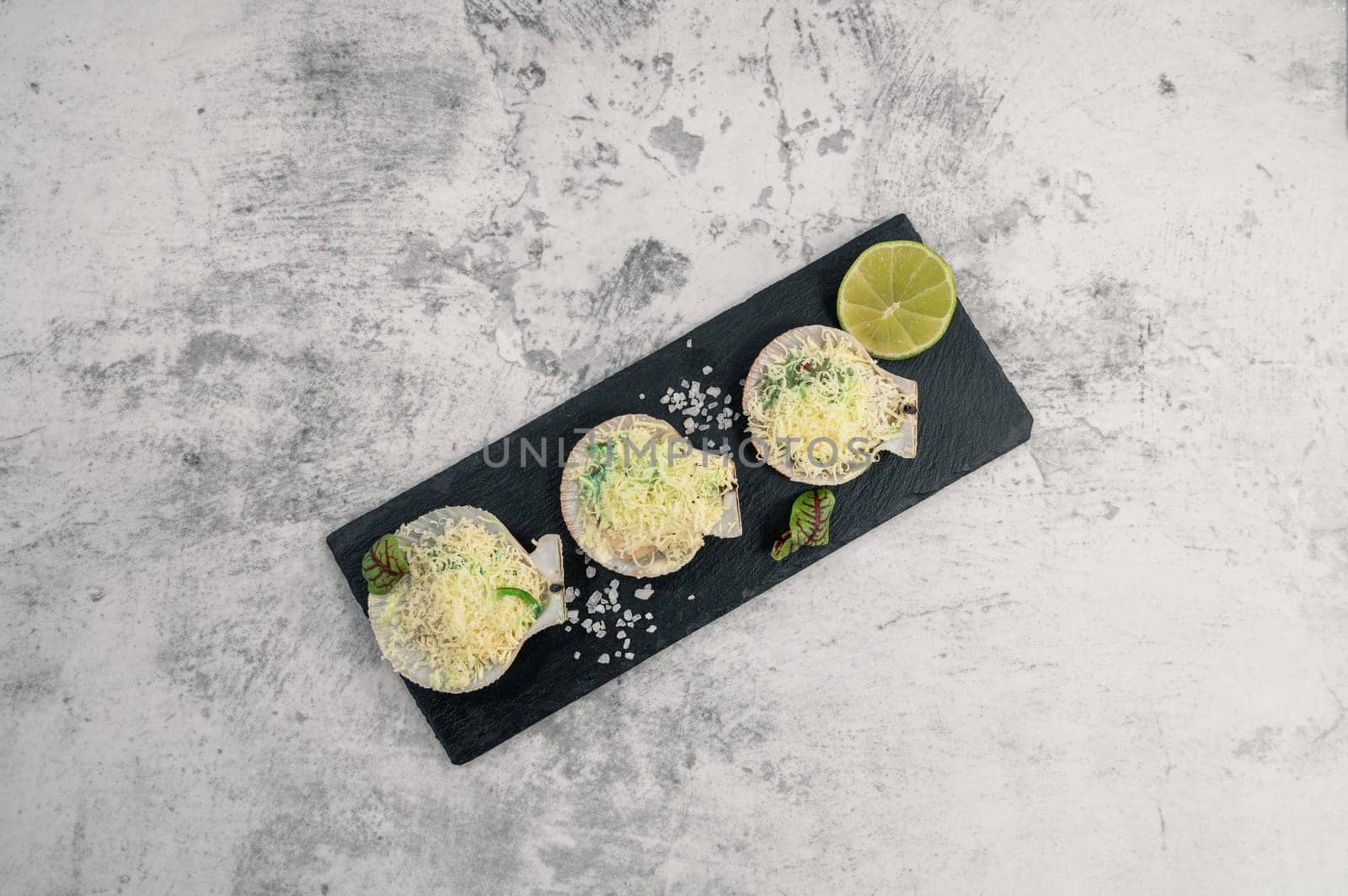 Delicacy roasted scallops with cheese spices and chuka algae