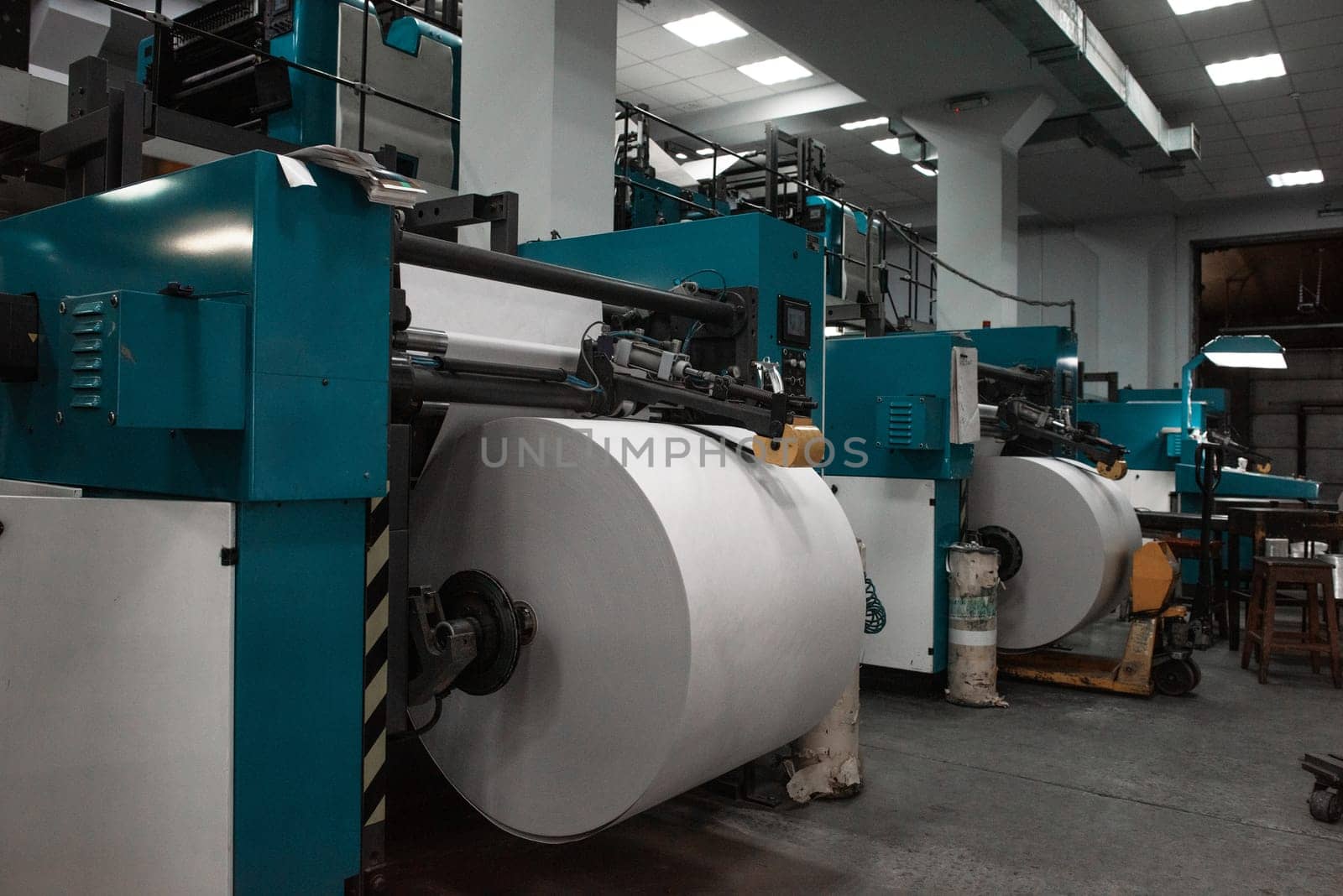 Printing house warehouse interior with printing machine