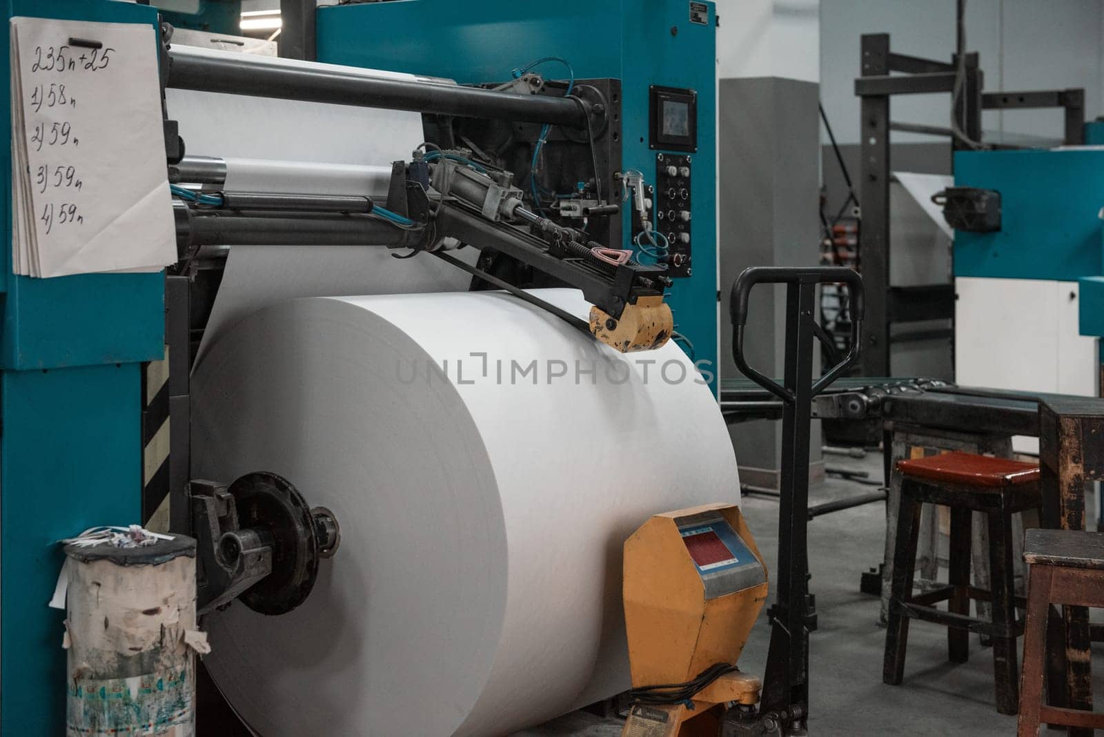 Printing house warehouse interior with printing machine