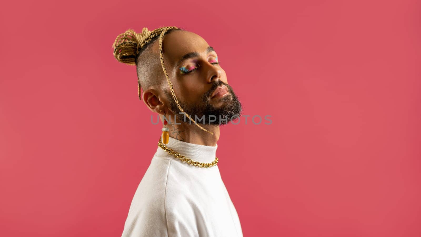 Trendy black latin gay man in white clothes with closed eyes isolated on pink background studio portrait People lifestyle fashion lgbtq concept