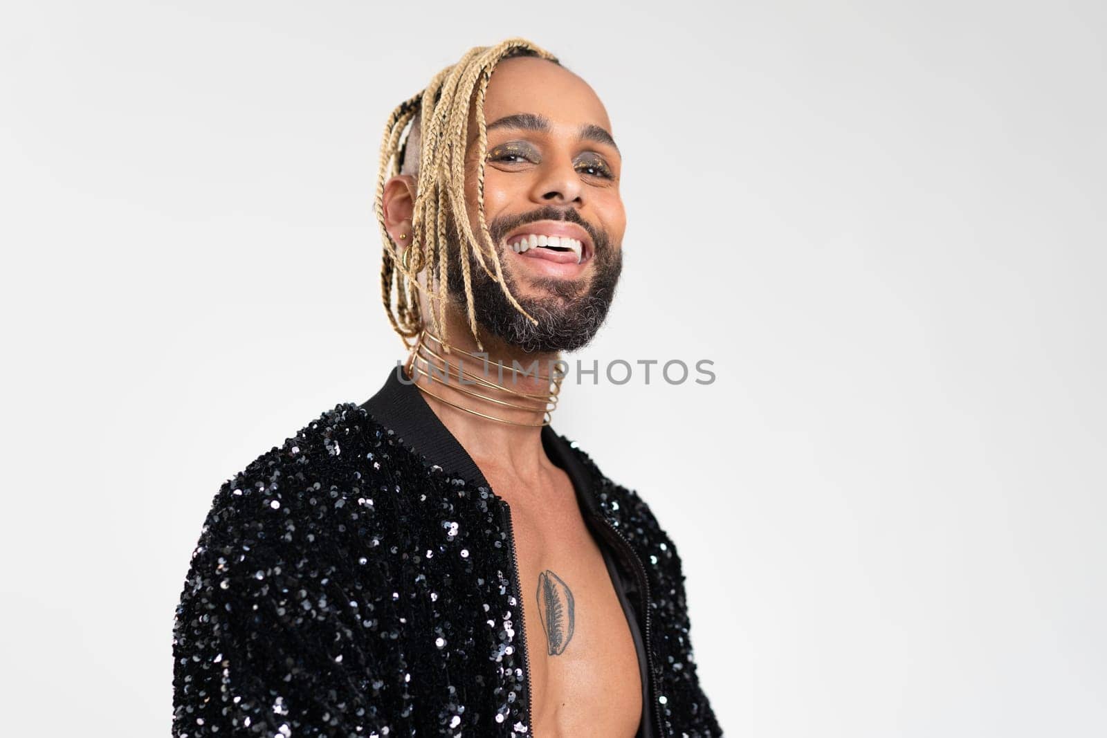 Afro-american homosexual male smiling isolated on white background. Bearded gay with beard and make up close up portrait