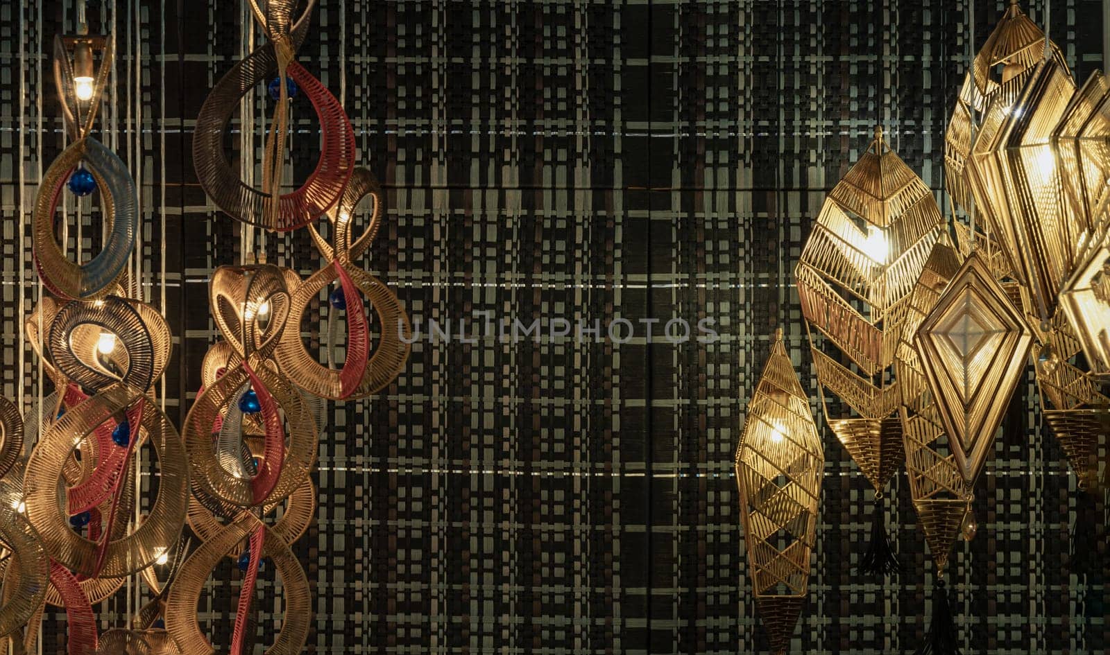 Bangkok,Thai - Apr 29, 2022 : Softly shining hanged lamps decor design with Braided Colorful Ropes for living room on dark background. Space for text, No focus, specifically.