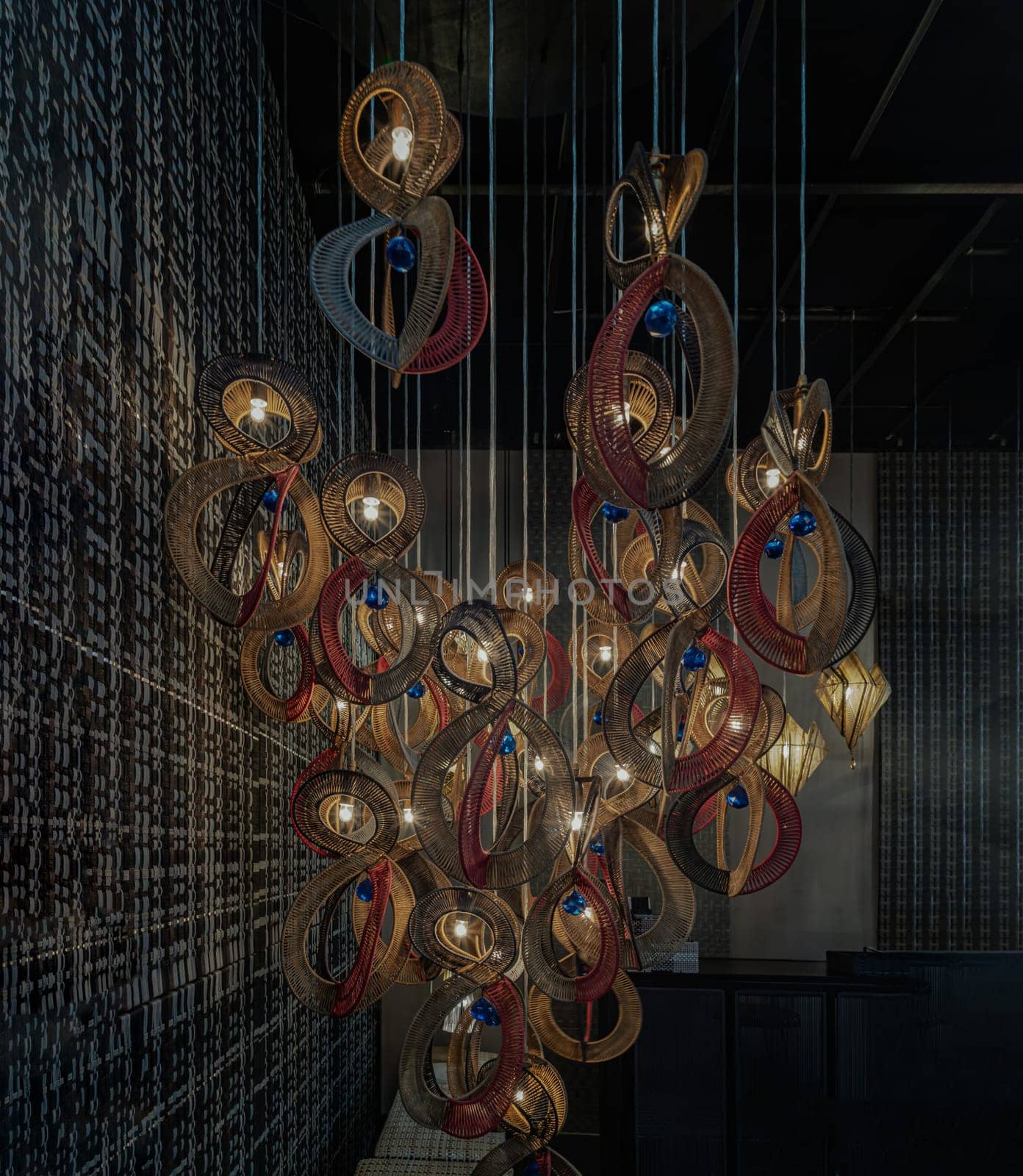 Bangkok,Thai - Apr 29, 2022 : Softly shining hanged  lamps with Braided Colorful Ropes, which means in Chinese Lucky Number Eight with dark background. Beautiful decor for the interior, 8 infinity unlimited lucky signs concept, No focus, specifically.