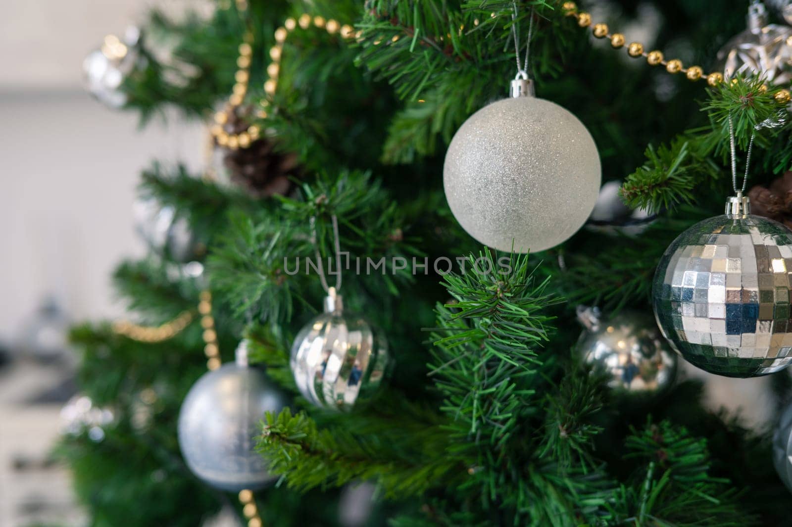 Christmas tree branch decorated with beauty balls and other christmas tree decoration