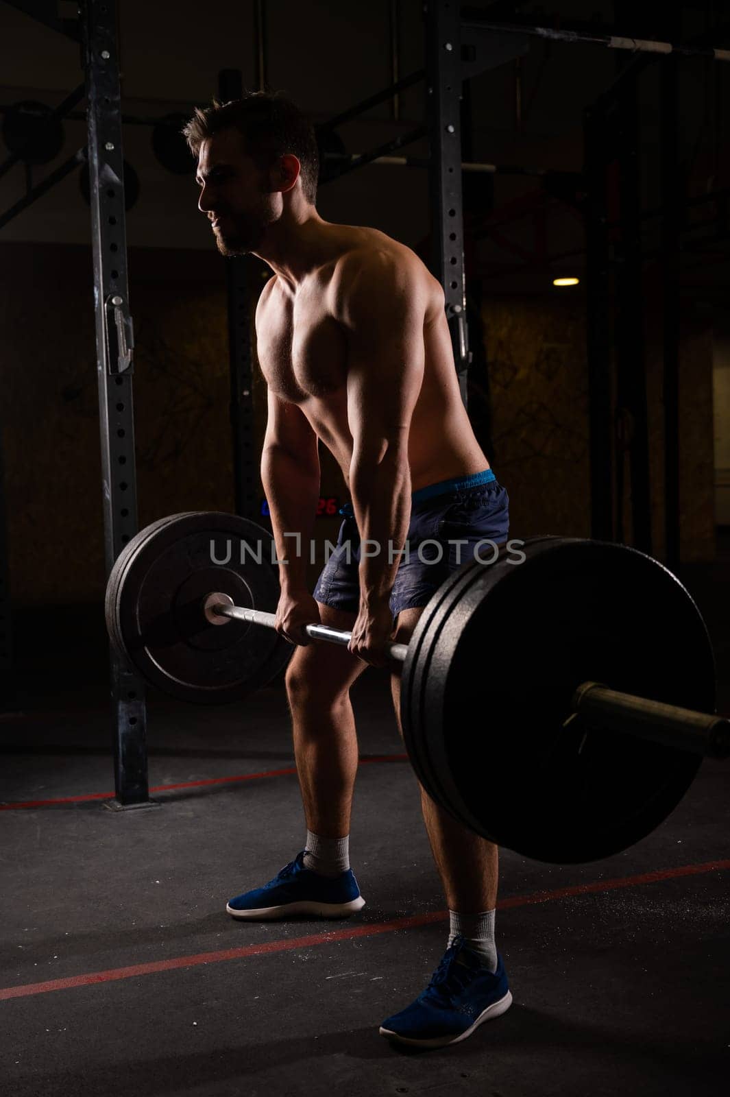 Shirtless caucasian man doing deadlift in the gym. by mrwed54