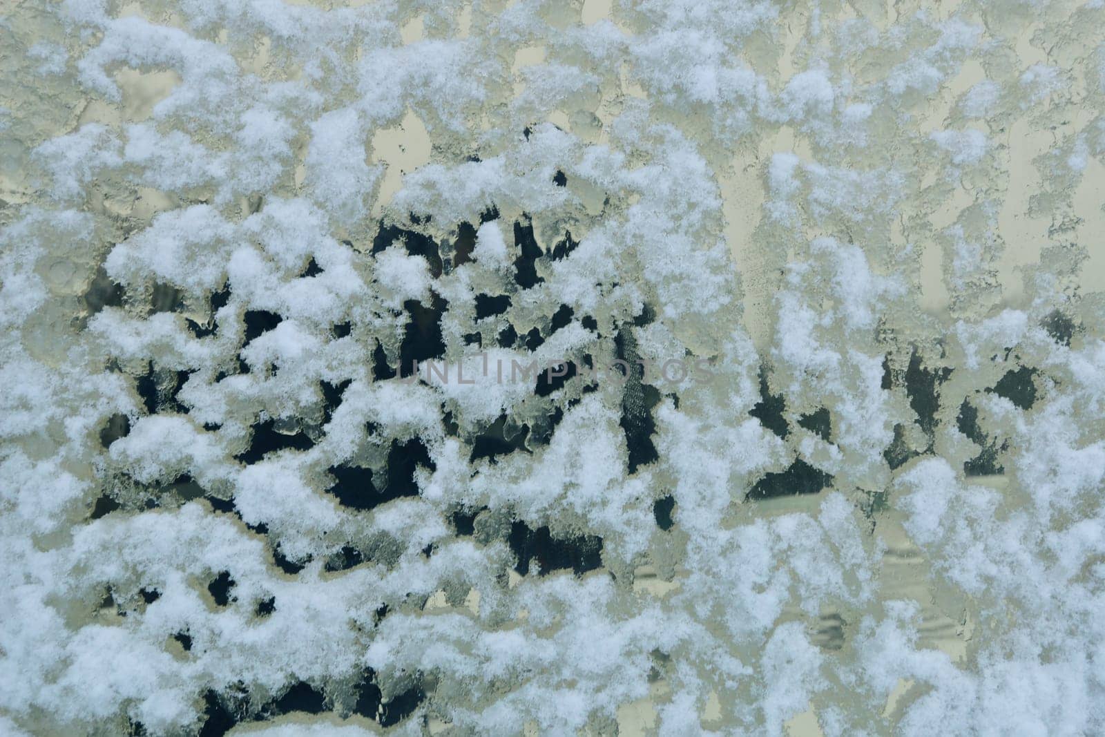 The surface of the window in the snow in bad weather. by gelog67