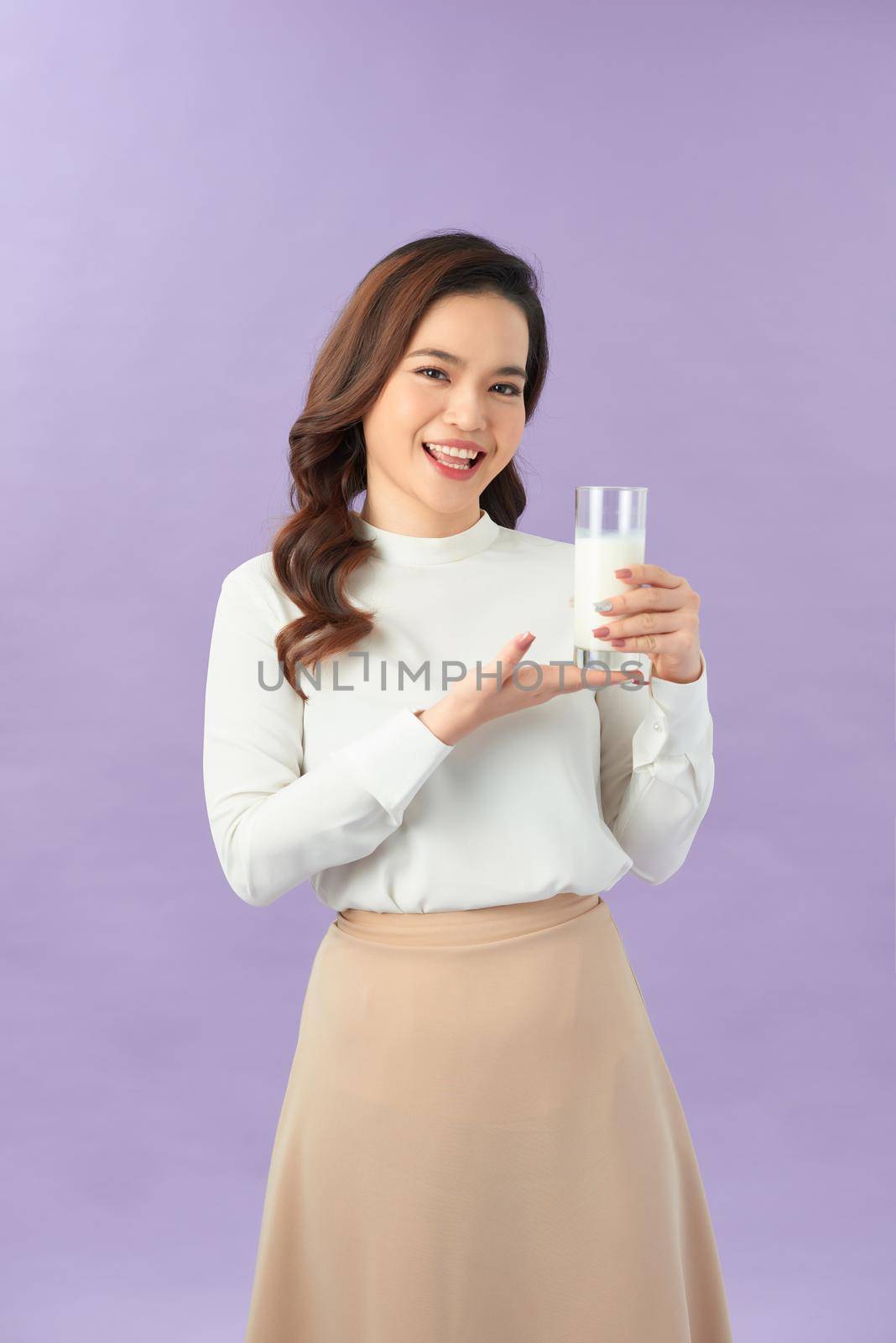 Wellness beauty woman holding a glass of milk in her hand  by makidotvn