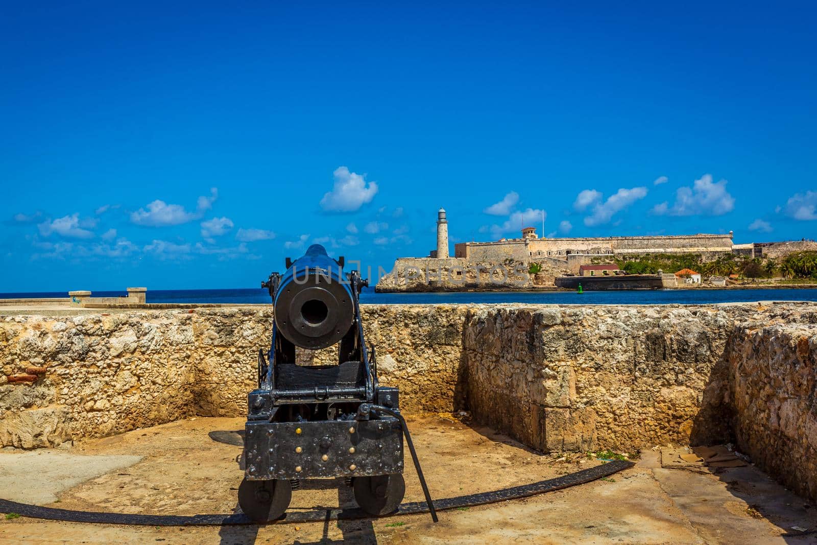 Morro Castle (Castillo del Morro) and lighthouse across Havana harbor, with Cannon in foreground, Havana, Cuba