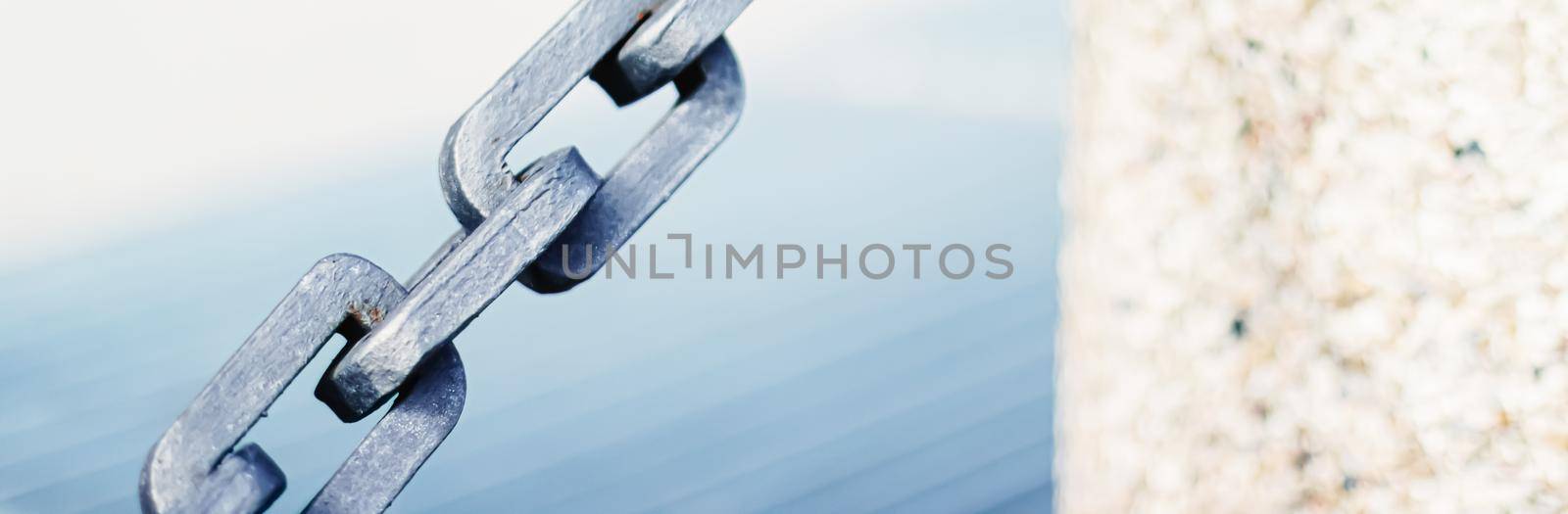 Metal chain closeup, marine background.