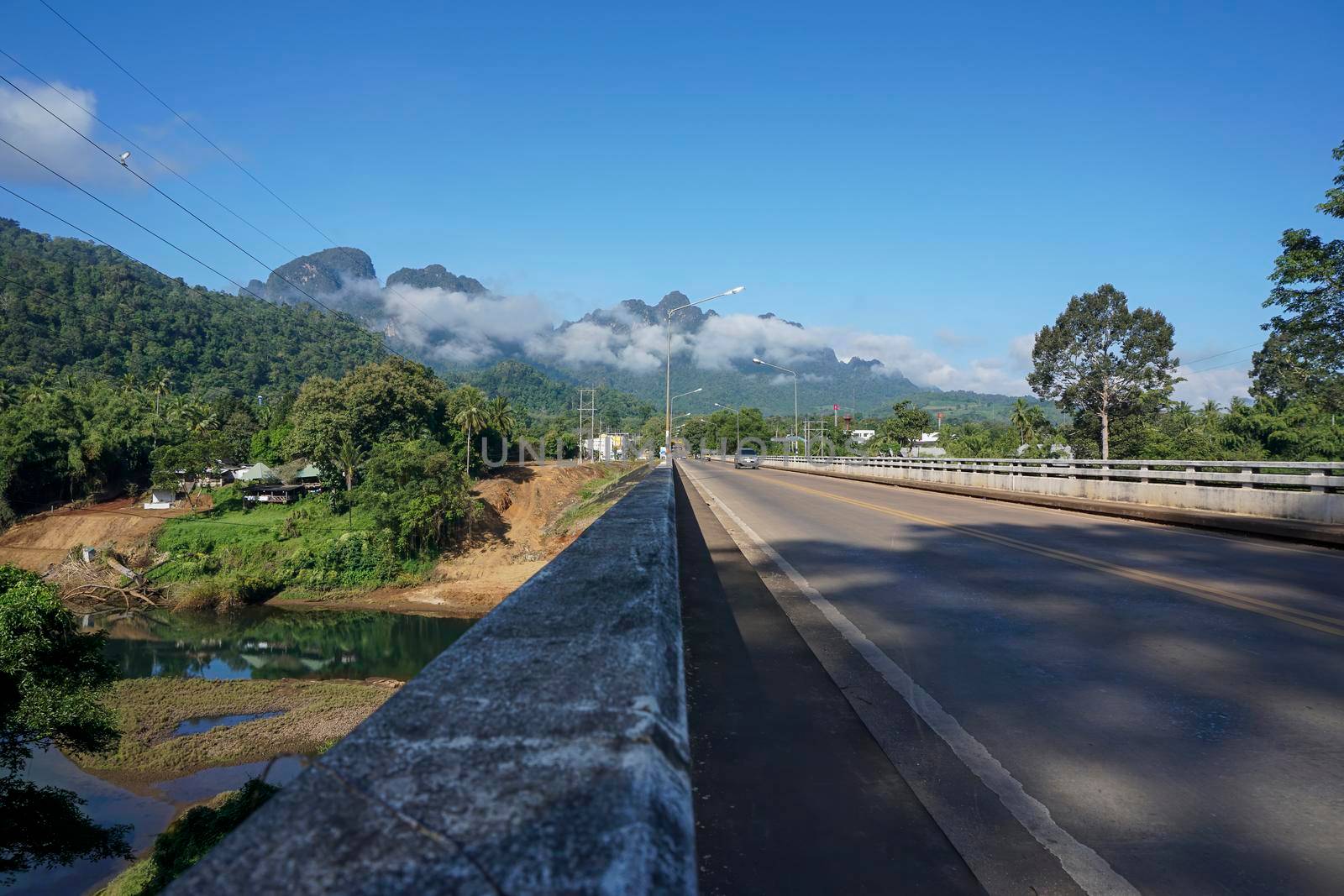 The destination of the road is a foggy mountain road to Pilok Village, Kanchanaburi Province, Thailand.