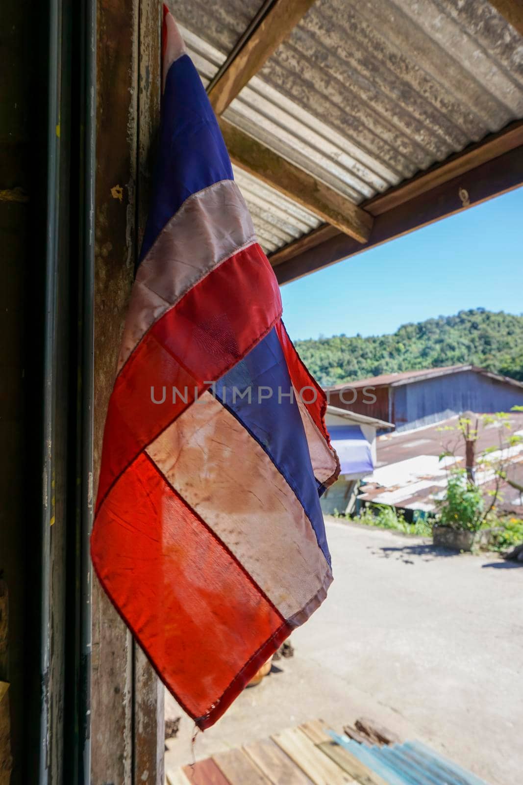 Thailand flag Hang in front of the house. E-Tong Village, Pilok Mine, Kanchanaburi, Thailand in the afternoon - 12 November 2016
