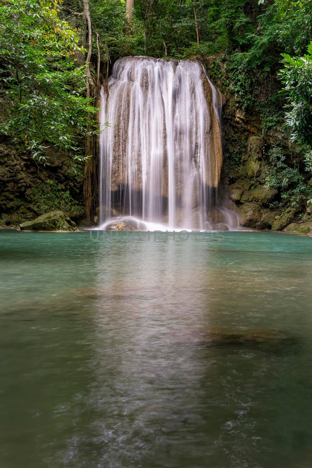 Clean green emerald water from the waterfall Surrounded by small trees - large trees,  green colour, Erawan waterfall, Kanchanaburi province, Thailand