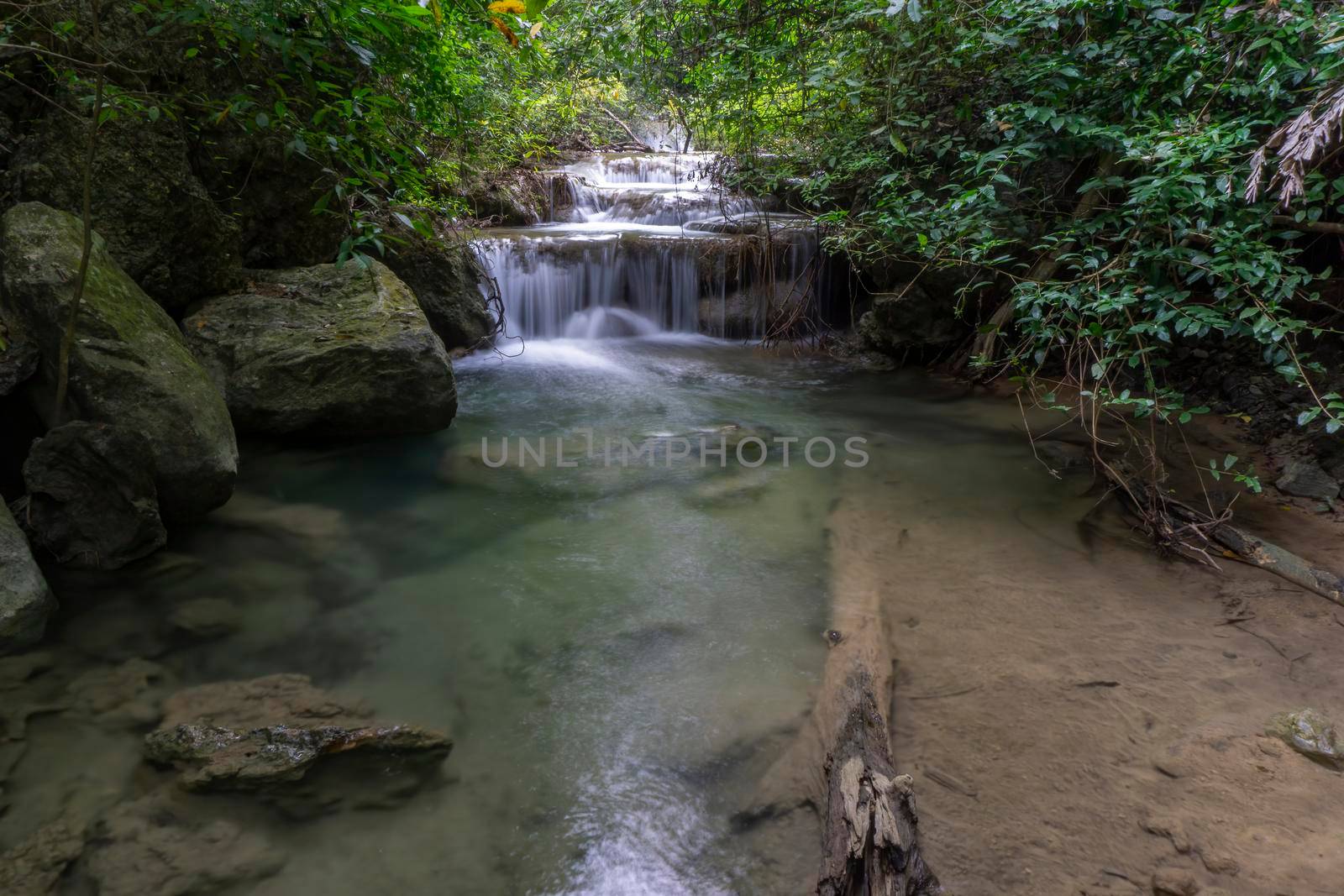 Clean green emerald water from the waterfall Surrounded by small trees - large trees,  green colour, Erawan waterfall, Kanchanaburi province, Thailand
