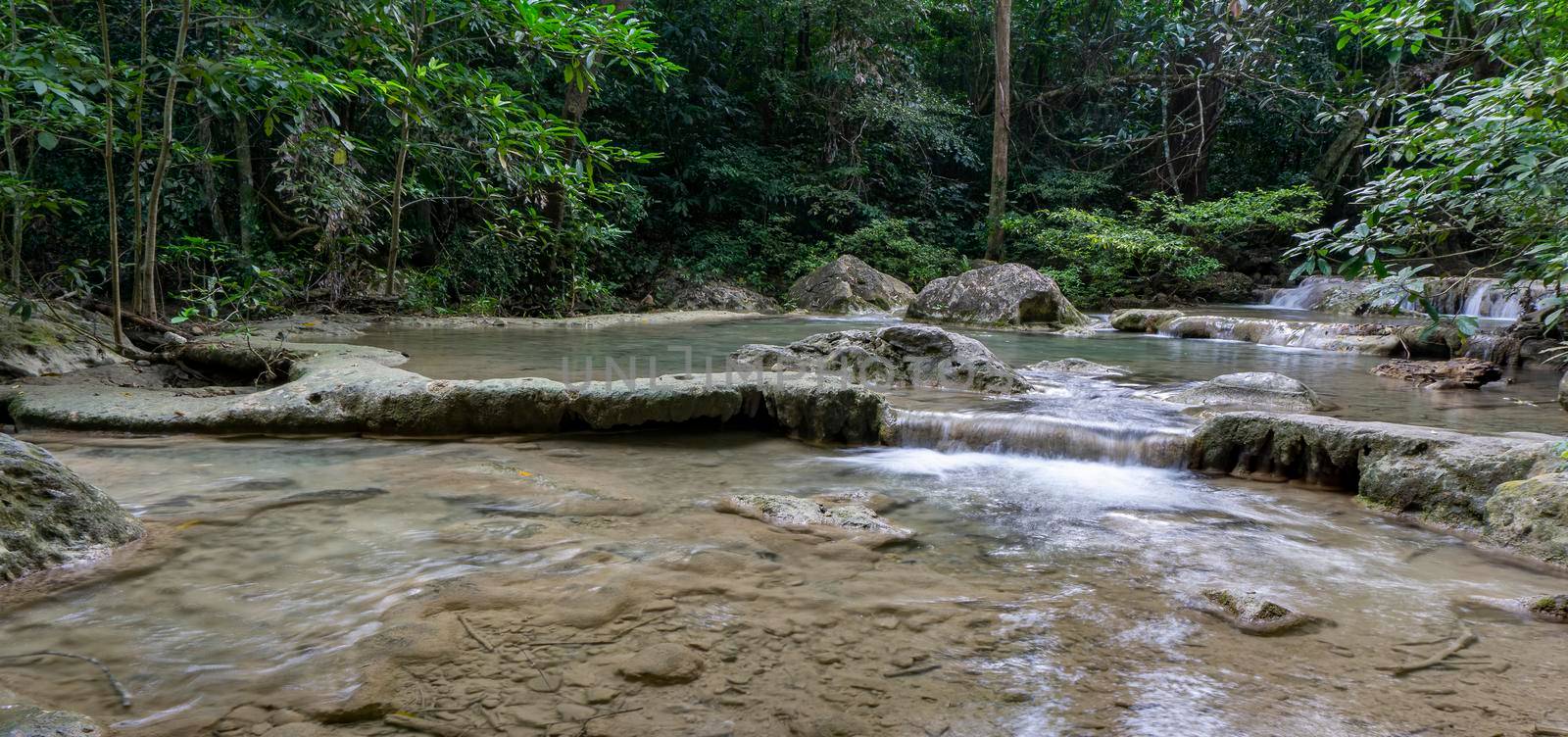 Clean green emerald water from the waterfall Surrounded by small trees - large trees,  green colour, Erawan waterfall, Kanchanaburi province, Thailand