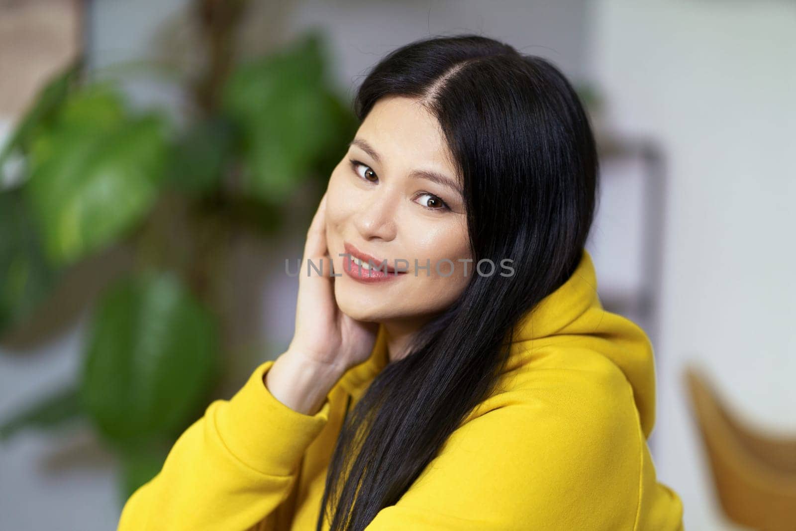 Pretty middle-aged Asian woman with healthy, glowing facial skin and well-groomed hair, promoting concept of healthy lifestyle. Woman radiates confidence, vitality, and well-being, in harmony with nature and her surroundings. High quality photo