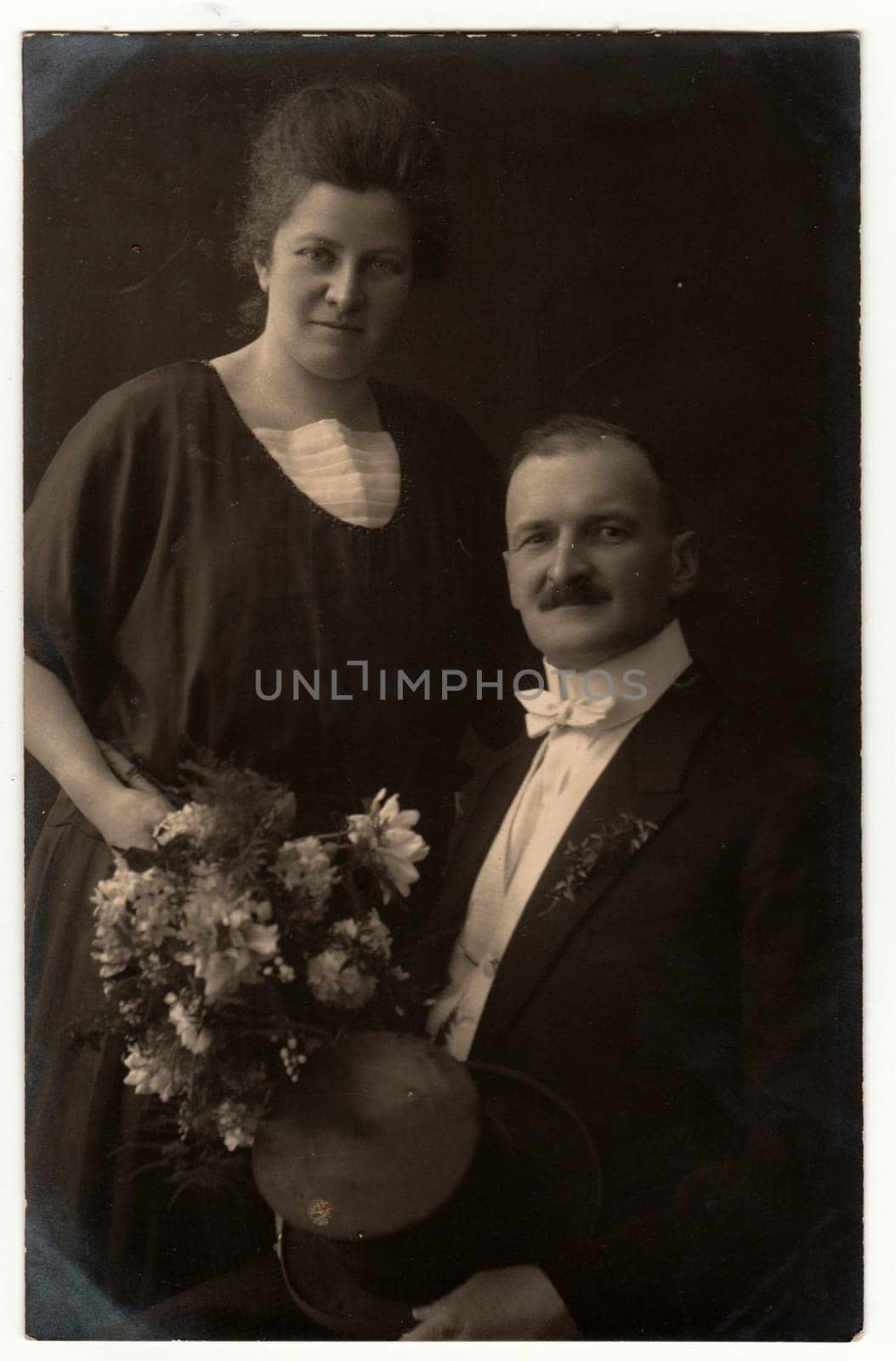 Vintage photo shows an elderly couple. Retro black and white studio photography. Circa 1920s. by roman_nerud