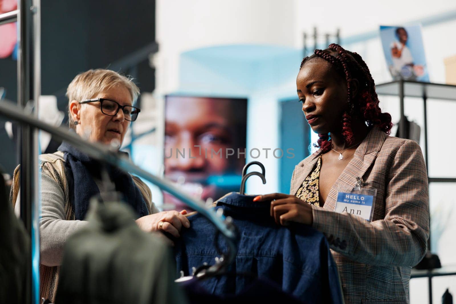 African american worker helping senior customer by DCStudio