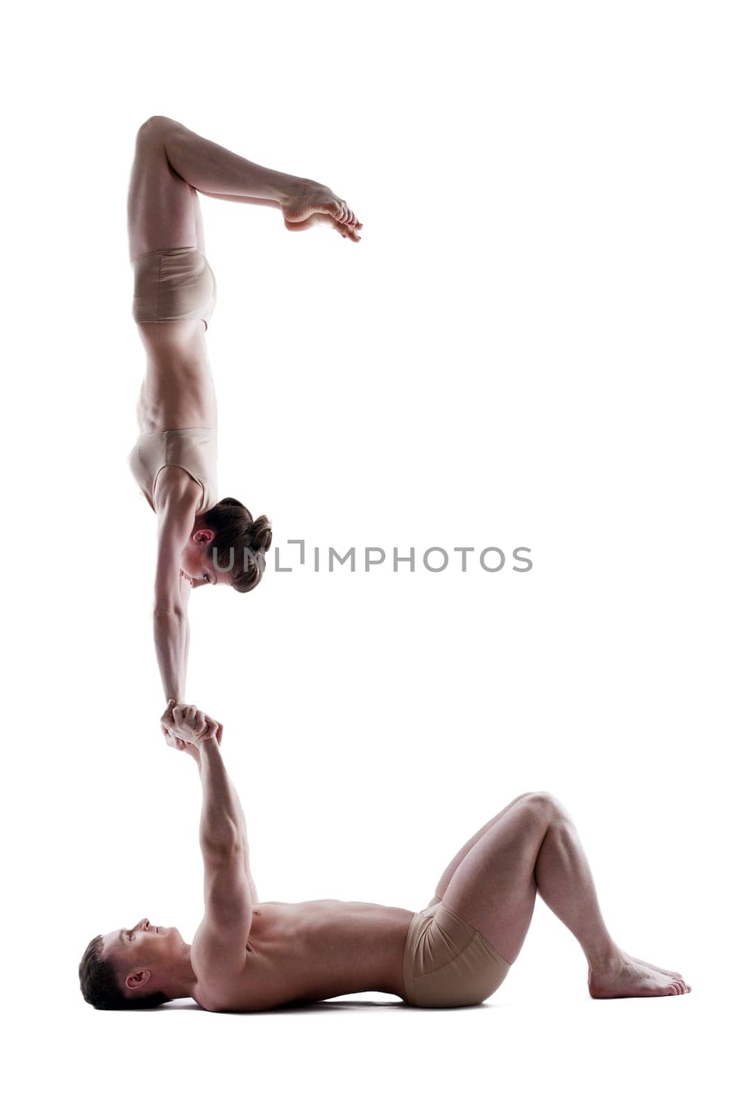 Flexible young couple posing in studio, isolated on white