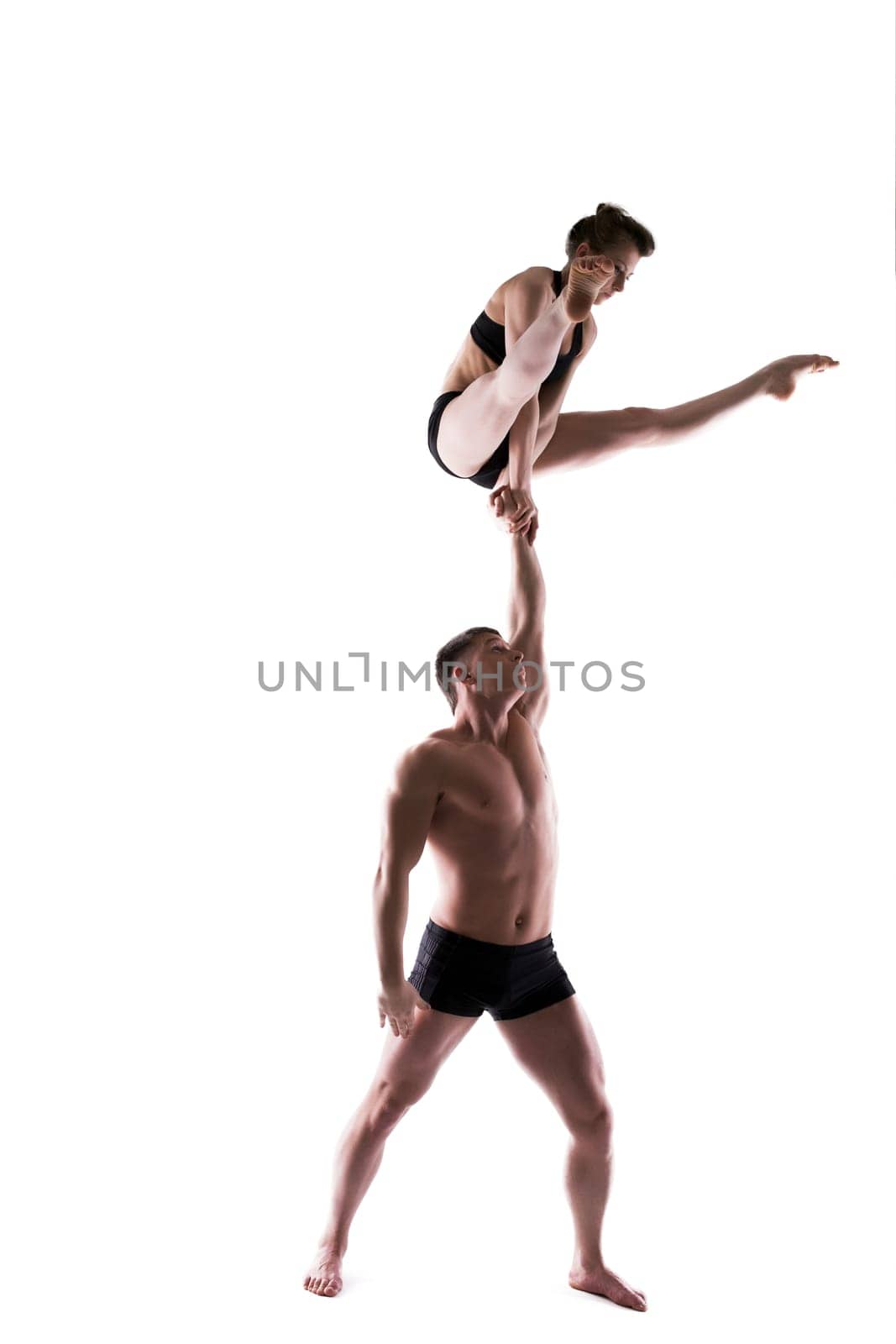 Young sporty people posing in studio, isolated on white