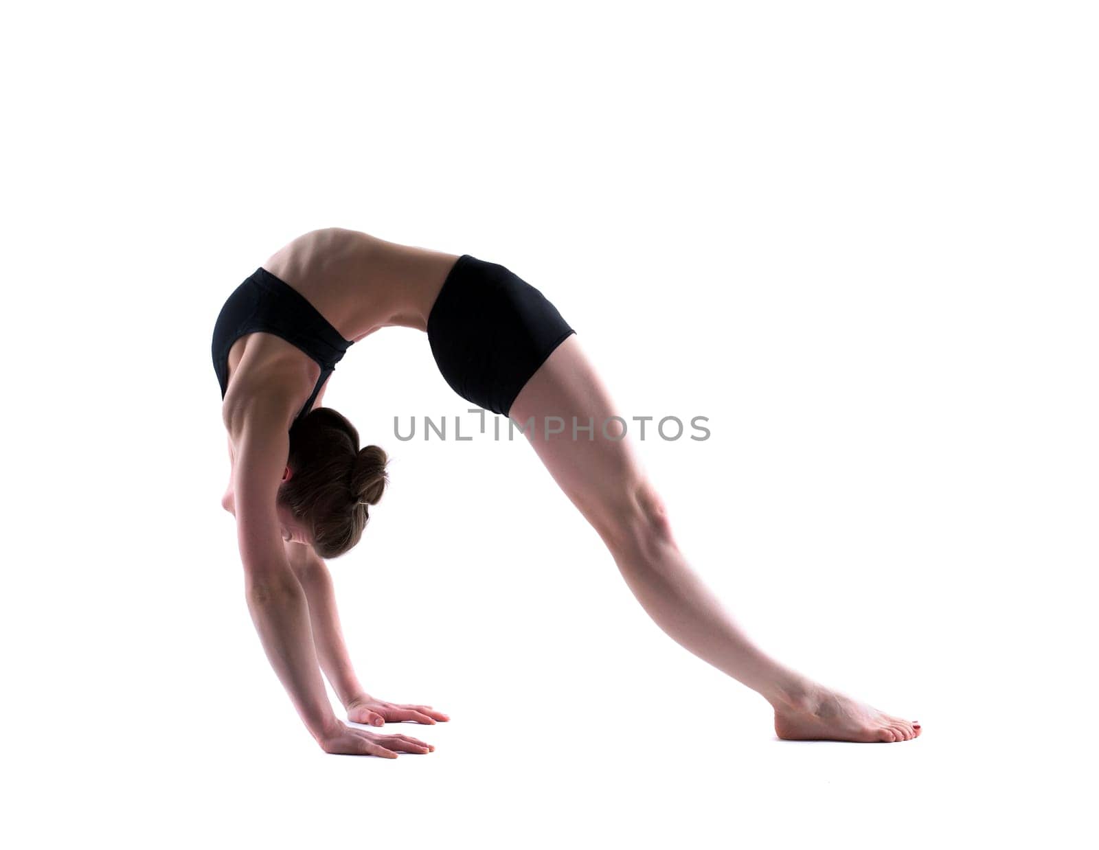 Image of young flexible girl in studio, isolated on white