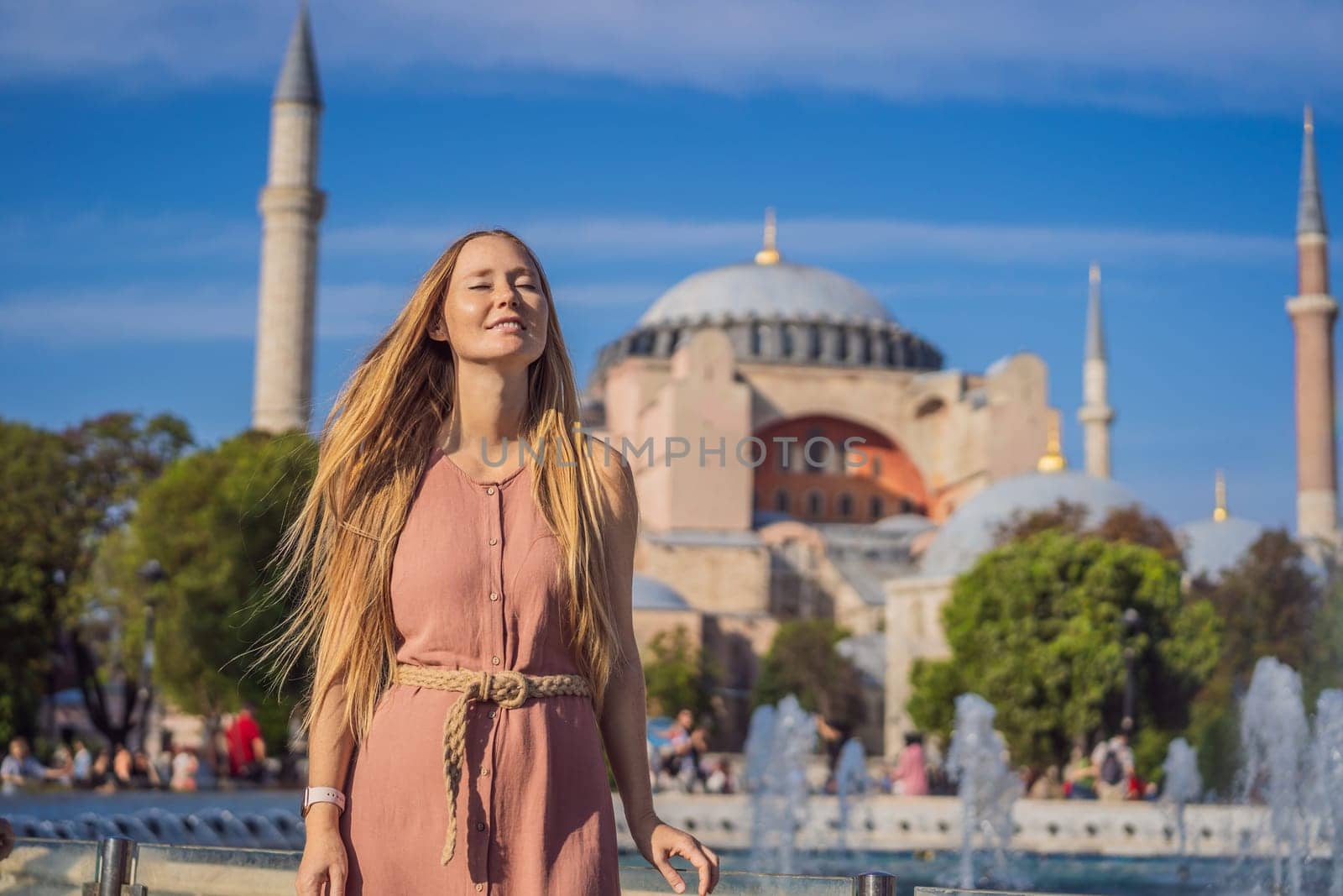 Woman enjoy beautiful view on Hagia Sophia Cathedral, famous islamic Landmark mosque, Travel to Istanbul, Turkey. Sunny day architecture and Hagia Sophia Museum, in Eminonu, istanbul, Turkey. Turkiye by galitskaya