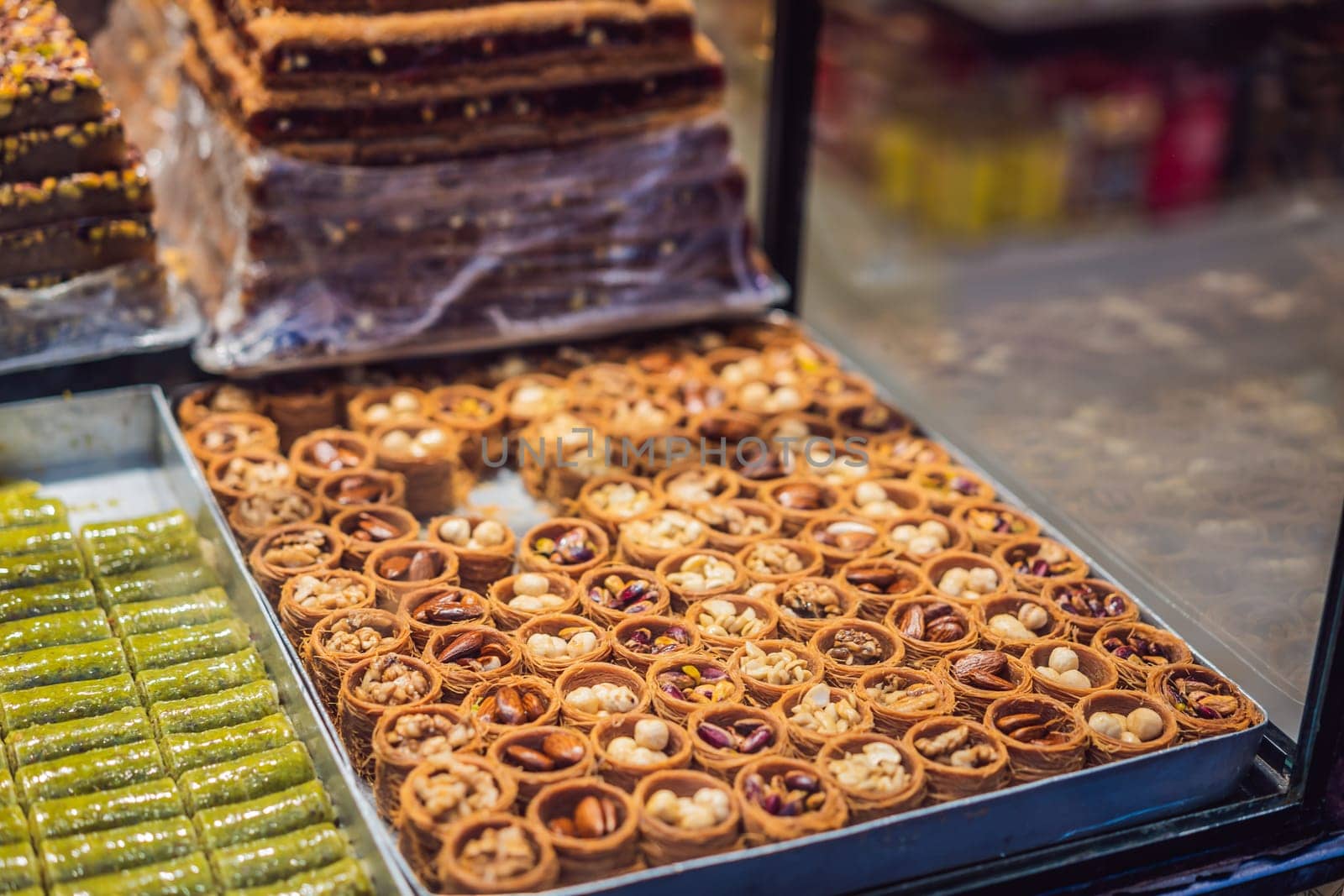 Traditional oriental sweet pastry cookies, nuts, dried fruits, pastilles, marmalade, Turkish desert with sugar, honey and pistachio, in display at a street food market by galitskaya