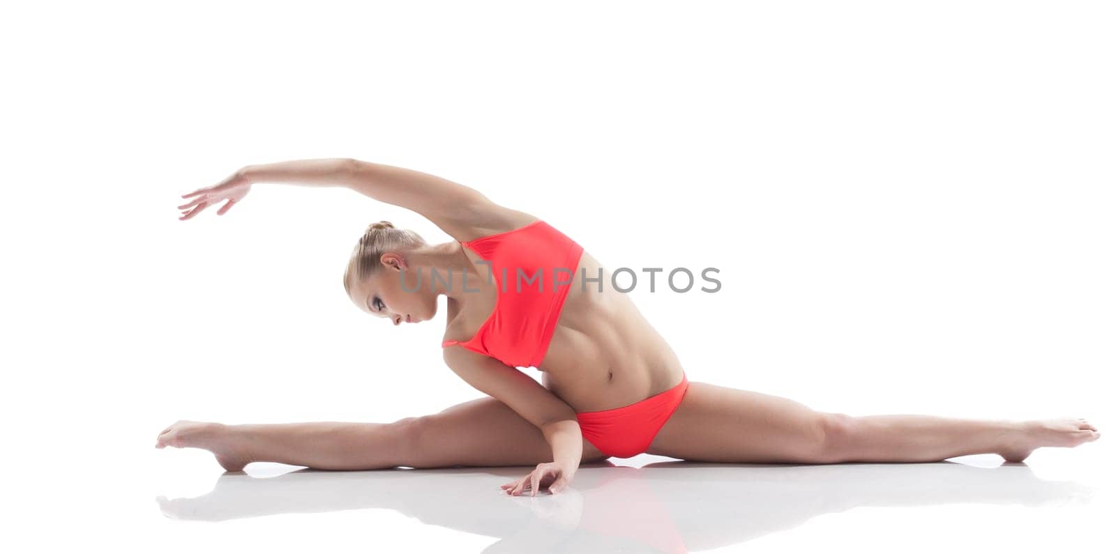 Young beautiful woman sitting on split, isolated over white background